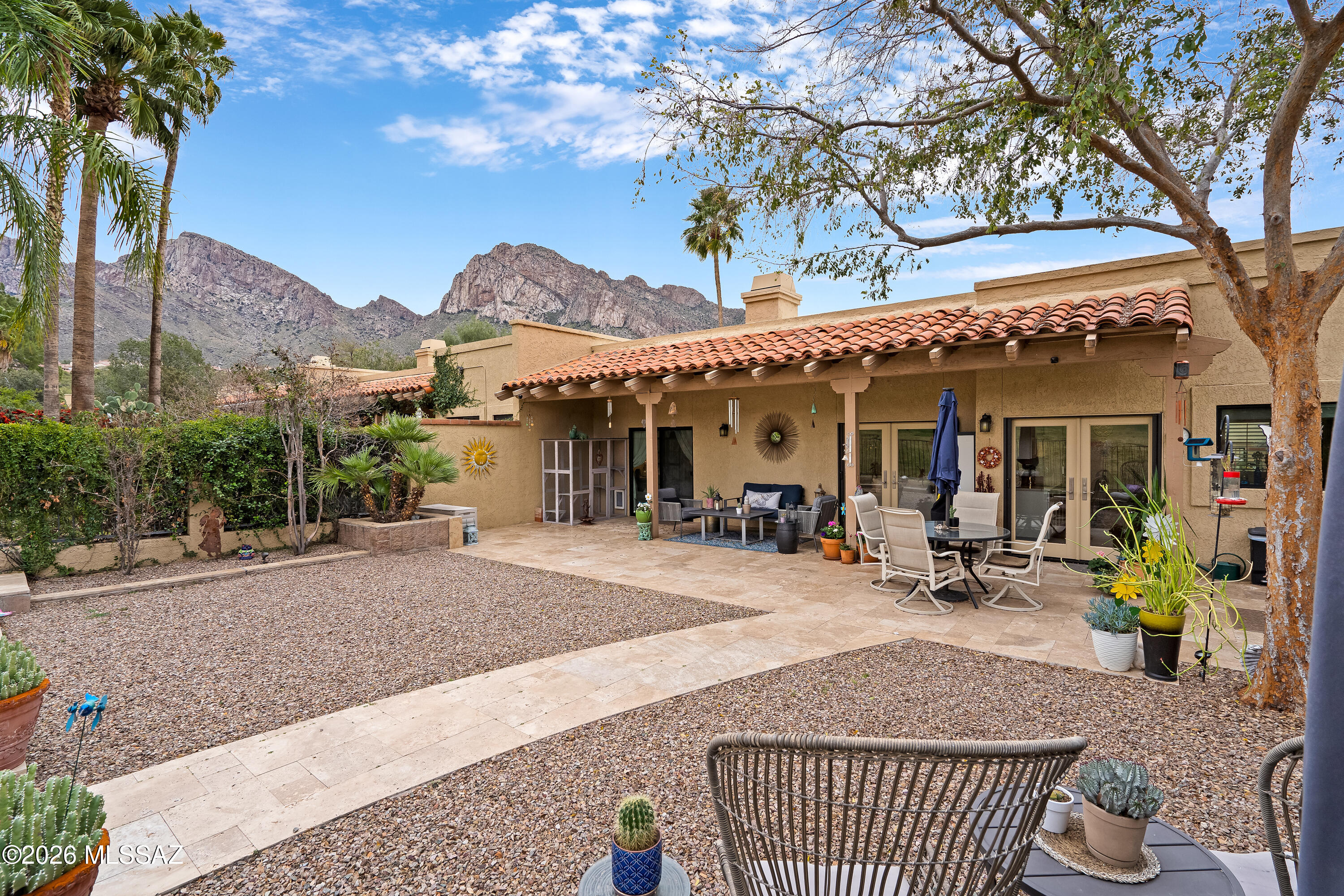 Highly sought-after El Conquistador Resort Patio Home ideally positioned on the 3rd fairway of the Pusch Ridge Golf Course, offering sweeping golf course and Catalina Mountain views from a premium end-unit setting.

This extensively upgraded and meticulously maintained 3-bedroom, 2-bath residence showcases engineered white oak flooring, abundant natural light, and a thoughtfully designed open-concept layout ideal for both everyday living and entertaining. The remodeled kitchen features Cambria quartz countertops, custom Bertch USA cabinetry with soft-close drawers, designer tile backsplash, and premium Bosch stainless steel appliances including dishwasher, microwave, and range/oven. An oversized island anchors the space, creating the perfect setting for gathering. The great room is highlighted by a striking floor-to-ceiling tiled fireplace, while French doors with Phantom retractable screens open to a private covered patio overlooking lush fairways -- creating seamless indoor-outdoor Arizona living.

The primary suite serves as a private retreat with serene views and patio access. The spa-inspired bath features a beautifully tiled walk-in shower with a rain shower head, and a spacious walk-in closet offering abundant storage and functional, elegant organization. Two additional bedrooms offer flexibility for guests, a home office, or hobby space. Every closet throughout the home is equipped with lighting, and multiple additional interior closets provide valuable storage rarely found in comparable patio homes.

Additional upgrades include a reverse osmosis system and whole-home soft water system, enhancing everyday comfort and convenience. The attached two-car garage provides direct access and includes an impressive dedicated storage area, ideal for seasonal décor, golf equipment, or lock-and-leave convenience.

Enjoy tranquil resort-style living adjacent to the Hilton El Conquistador Resort, with close proximity to golf, dining, shopping, and outdoor recreation. HOA covers community maintenance for truly low-maintenance ownership.

Most furnishings available under separate bill of sale, offering a turnkey option for seasonal or second-home buyers.