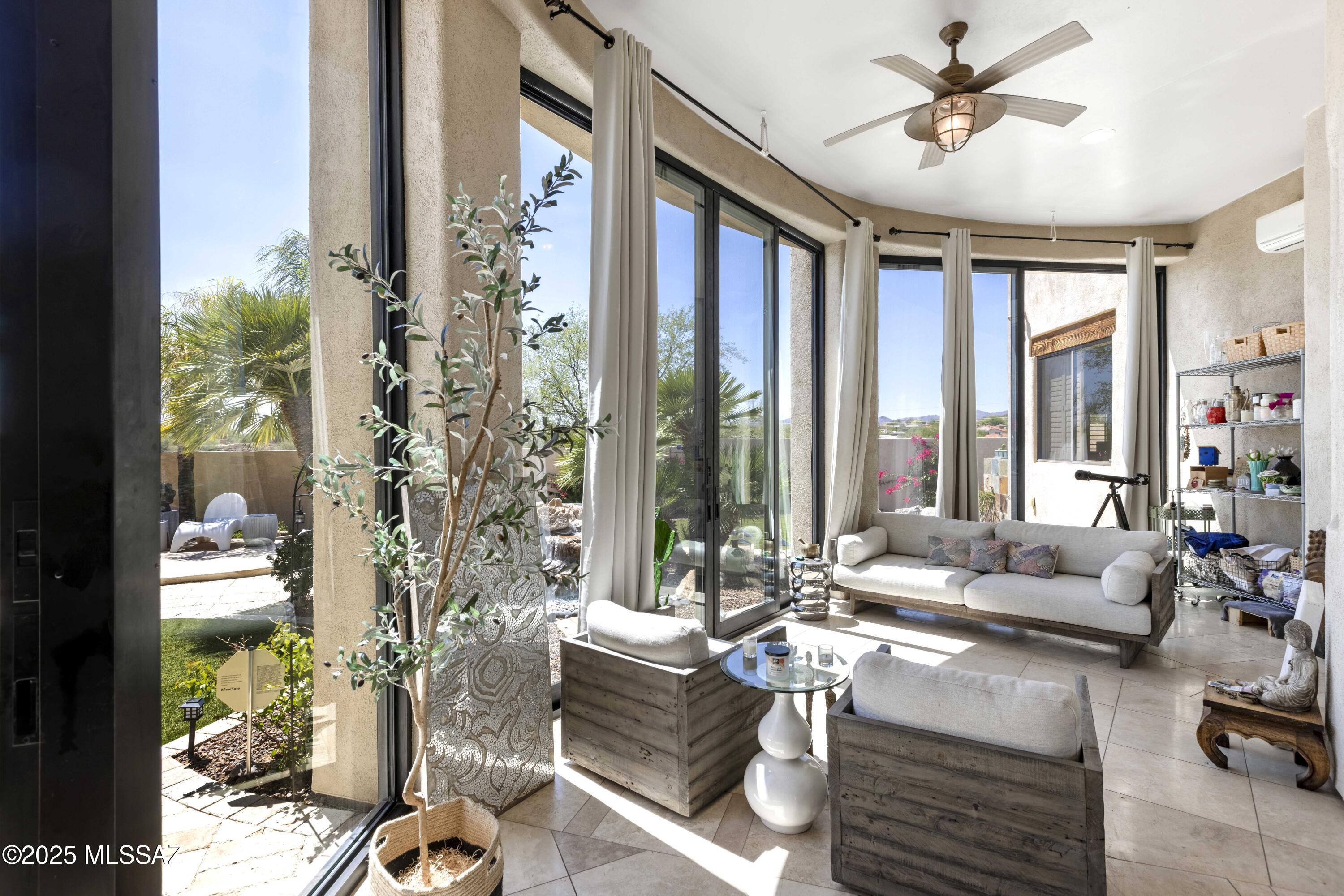 Enjoy sweeping unobstructed Catalina Mountain Views in this well maintained luxury custom home designed by renowned Tucson architect Marc Soloway. Perched high on a hilltop in a private gated enclave of just 4 homes, this 4Bd+Den/Dining &  3 Car Garage beauty is perfectly positioned on OVER 1 ACRE and No HOA. The main residence boasts 2,708 sq ft of refined interior space, complemented by 394 sq ft of either 3rd Car Garage space OR currently used as a home gym and studio space. No detail was overlooked in the extensive updates-Custom natural stone floor tile stretches wall to wall & imported glass tile elevates the home's 2 stunning beehive fireplaces. The spacious fully enclosed yard offers both city light views & a sparkling free form swimming pool, sauna & room for a future casita too! Luxury amenities abound-including high ceilings, remote-controlled sunshades and blinds, custom California Closets built-ins and garage storage, and a full home Waterdrop R/O system and softener system.  All doors have been replaced with exquisite custom glass insets throughout.  The remodeled kitchen showcases a sleek waterfall island, Induction Cooktop by Fisher Paykel, Bosch Convection Oven and Dishwasher and Samsung Fridge and Microwave. The owner's bath was completely reimagined in 2024 with a luxurious Kohler shower, freestanding soaking tub, and designer finishes.
Outdoor living rivals any five-star resort: a tranquil Japanese Zen Garden with Finnish sauna, two elegant water fountains, the sparkling pool, and expansive Travertine patios surrounded by lush turf and vibrant landscaping. The fully air conditioned Sun Room, with floor-to-ceiling sliding glass doors (10' tall!) seamlessly connects indoor and outdoor spaces, making every sunset feel like a private event. 
Conveniently located 5 minutes from Naranja Park featuring Pickleball courts, Soccer Fields, a Splash Pad and even Archery!
This home is a rare fusion of architectural pedigree, thoughtful upgrades, and desert serenity crafted for the most discerning buyer.