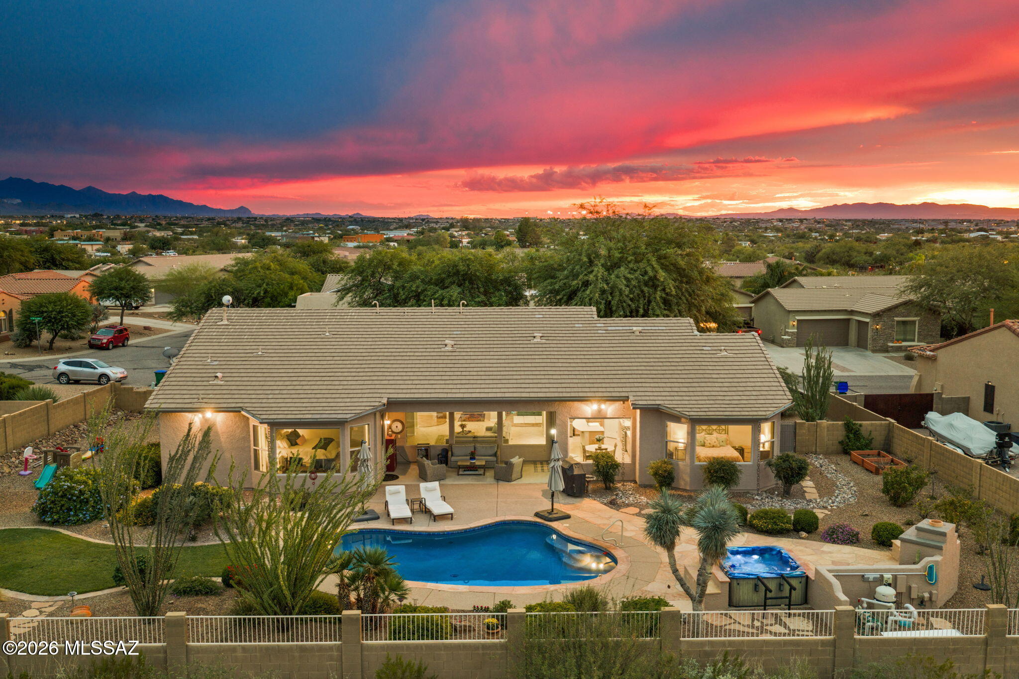 From the moment you step inside, the view takes center stage. Sweeping mountain and desert vistas unfold beyond the windows, creating a striking backdrop throughout nearly every room of this delightfully appointed home.

Designed for both relaxed everyday living and memorable gatherings, the home offers four bedrooms, a den, three full bathrooms, formal dining, a spacious great room, and a gourmet kitchen with breakfast nook. 

A thoughtfully designed kitchen welcomes cooks and entertainers alike, highlighted by a new expanded double-oven range and generous workspace.

The primary suite feels like a private retreat, complemented by an extraordinary walk-in closet complete with upgraded shelving and drawers. Additional bedrooms also feature enhanced closet systems. Outside, the home becomes a destination of its own. The backyard captures expansive views across the valley to the Rincon Mountains, with dramatic sunrises, glowing sunsets, and ever-changing desert skies. A sparkling pool and hot tub, outdoor fireplace, covered patio, flagstone entertaining areas, putting green, raised garden beds, rain chains, automated irrigation, and colorful native landscaping come together to create a setting worthy of a private resort. Whether enjoying morning coffee as the mountains catch the first light, gathering around the outdoor fireplace on a cool desert evening, or spending an afternoon beside the pool, this is a backyard designed to make staying home feel like a getaway.

A three-car tandem garage provides abundant space for vehicles, storage, hobbies, or recreational gear, and comes with a work area and extensive cabinet space. Tucked on a quiet cul-de-sac, the home also enjoys access to a private neighborhood park with basketball and volleyball courts, walking trails, a covered picnic area, and a shaded playground.

Beautifully situated, thoughtfully upgraded, and framed by some of Southern Arizona's most captivating scenery, this is more than a home with a view. It is a home designed around the view.

Don't miss the opportunity to make it yours.



Buyer to verify facts and figures.