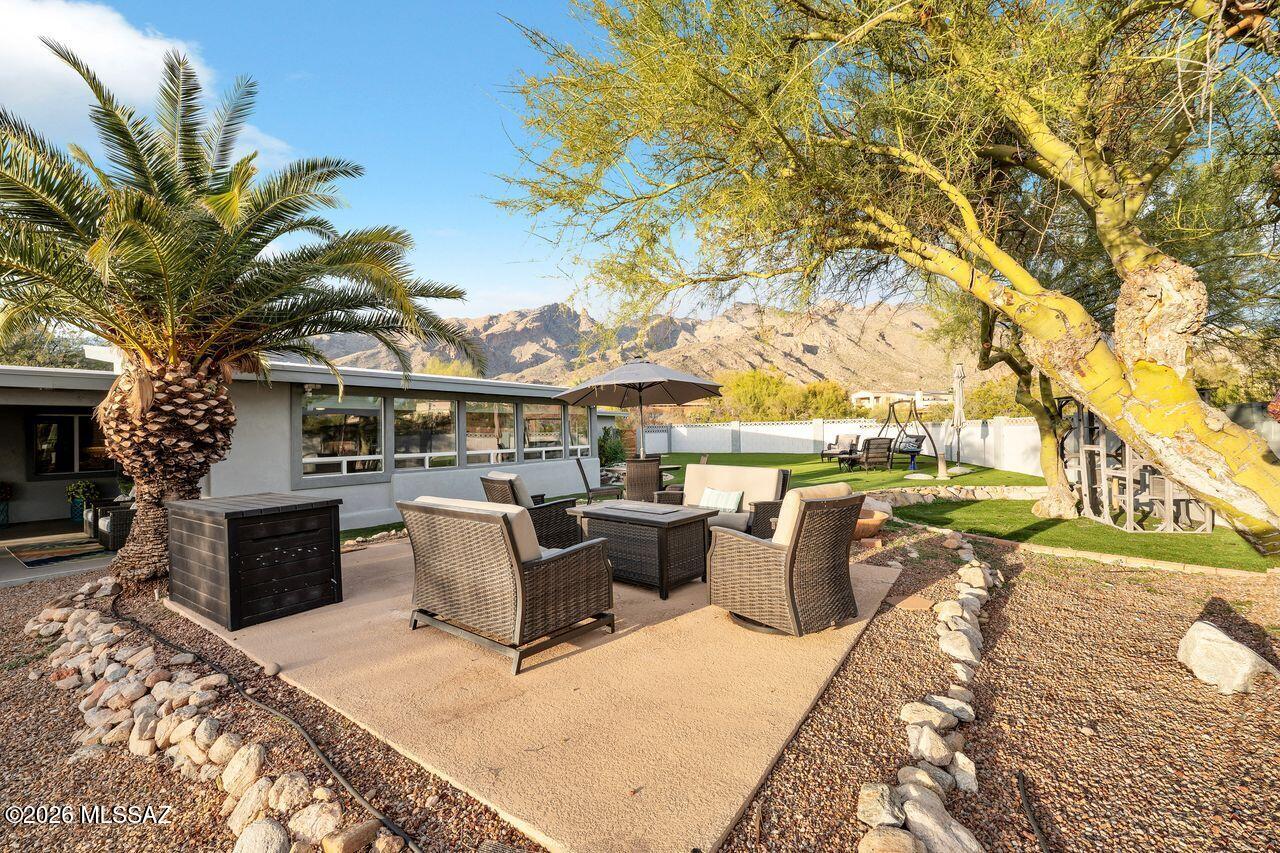 Central Foothills beauty with spectacular mountain views both front and back. Totally updated: kitchen, baths, AC, H2O heater, flooring, windows, and more! Very private lot which is slightly elevated. There are multiple outdoor areas for viewing the mountains, entertaining under the expansive covered patio, or watching the city lights start to emerge at dusk. The large family room has soaring ceilings, and the kitchen is a chef's dream with upscale appliances, 9-foot island with quartz counters. The kitchen is accentuated with both up and down lights on the cabinets. Custom etched glass adorns the wine room, pantry and laundry room. Enjoy a wall of windows for outdoor views. Huge rear yard is ready for pool, or keep it as is, low maintenance. Lots of storage off the two-car garage.