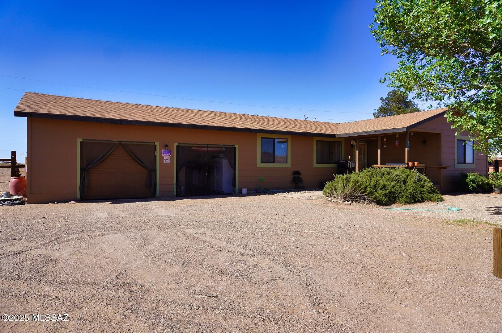 Mini-Farm/Homestead. 3 BR/2BA frame built home on 2.57 acres. Detached one car garage/workshop with power and is insulated. Plus a 2 car garage attached to the home with lots of storage closets. Roof replaced in 2021. Property is fenced for horses or other animals. Has a barn. Property is also gated with an automatic gate opener. Landscaping trees are on drip irrigation. Walking distance to the Mustang Mall. Sunizona Water co. with a septic. Central gas heat and newer central AC. Washer and Dryer and refrigerator convey. Back yard is fenced for dogs. No CC&R's. No HOA. Video Tour avail on this listing. look for the link
