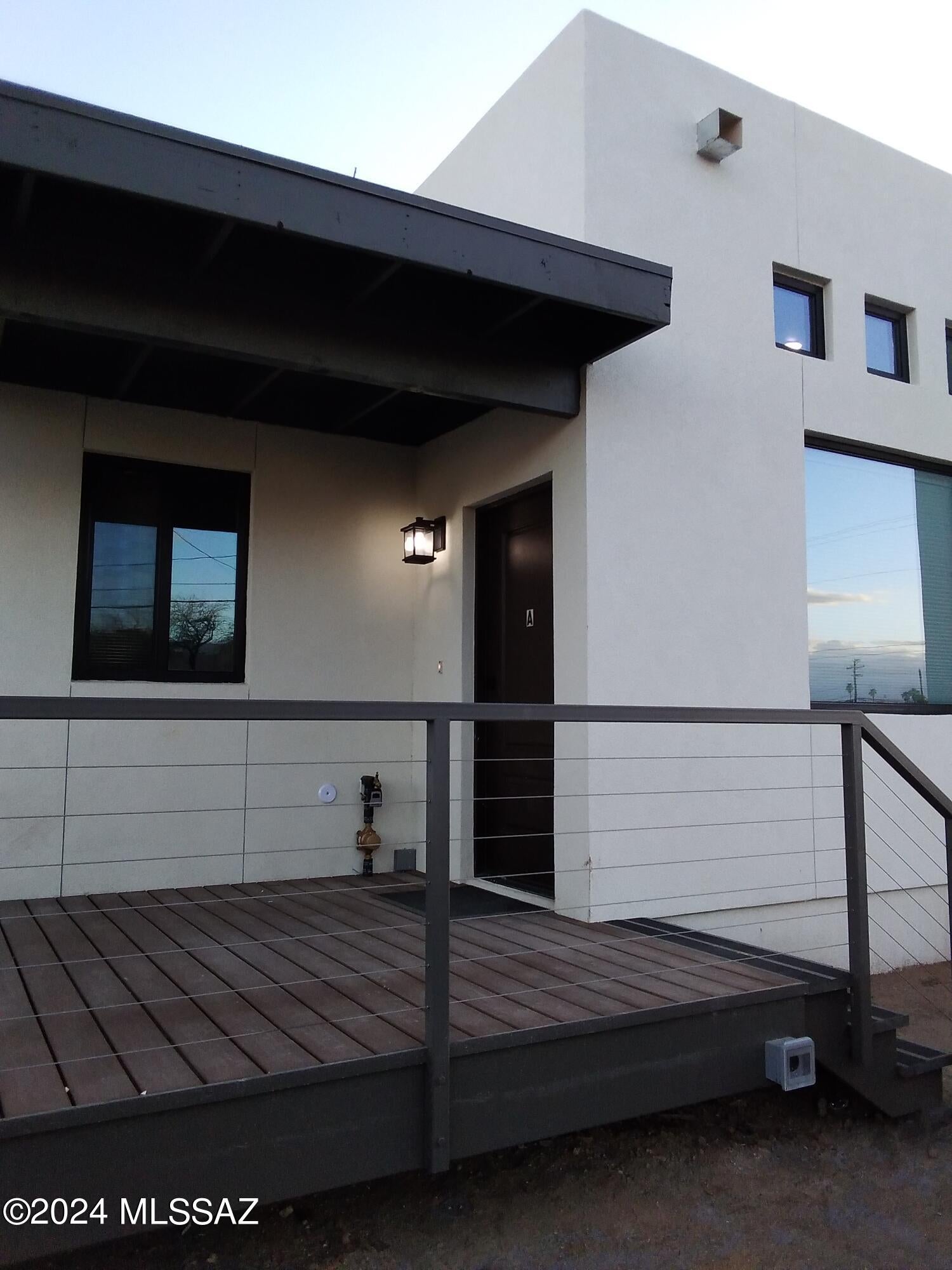 Sharp modern architecture offers curb appeal to this newer building . Wrought iron fenced all around. Gated parking with remote controlled rolling gates! Railed deck porch, security iron front door. High living room ceiling, clerestory windows. Sealed concrete floors.
Three roomy bedrooms with blinds & blackout curtains & fans. Laundry in hall with front loading washer and dryer. Ensuite primary bedroom. Kitchen flaunts induction range, French door refrigerator with ice maker, quiet dishwasher, microwave, open shelving, butcher block countertops, shaker style non-MDF cabinets.  Dual flush toilets, easy clean bath surrounds. Dedicated EVC outlet for your electric car! Close to UofA, Tucson Mall, Downtown, PCC. Did I mention Gorgeous? Check out this swanky pad today. OWNER/AGENT/LANDLORD Utilities are an extra $275 per month fixed. Security deposit is $1500. Pet fee is $300 per pet. Two pets allowed. EVC is $.19 per kWh if needed.
Halloweeny Special Offer! Lease by October 31 and pet fee is waived.  Dia de los Muertos Special Offer! Lease by November 1 and security deposit is only $1000. Offer ends November 2. Ask me about the Engineer's Special!