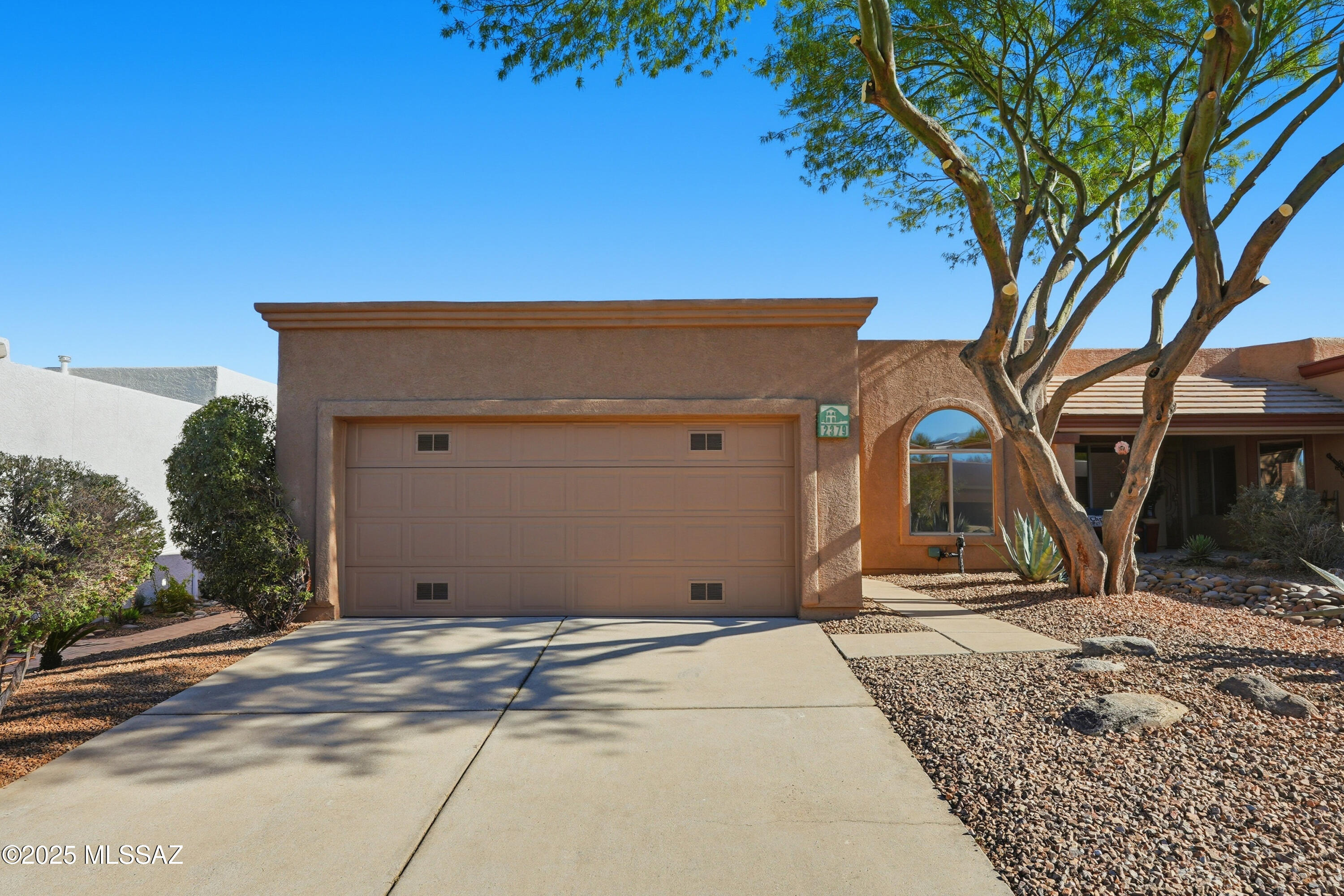 The exceptional gated community of Sunrise Pointe, where MOUNTAIN VIEWS, comfort, and versatility come together in one extraordinary townhouse. The moment you step inside, you'll notice the fresh, move-in-ready feel with brand-new interior paint that brightens every corner, complemented by sleek tile floors flowing throughout the main living areas and plush new carpet creating cozy retreats in the bedrooms. The heart of this home is the expansive living and dining area, where natural light pours in, and partial mountain views provide a stunning backdrop for everything from casual movie nights to elegant dinner parties. Adjacent to the main living space, you'll discover a versatile extra room that adapts to your lifestyle: transform it into a home office or a formal dining room perfect for entertaining. The well-appointed kitchen flows into a spacious breakfast nook, creating the perfect place to prepare delicious meals while sharing stories and laughing with loved ones. The thoughtfully designed split bedroom floor plan offers the ideal balance of privacy and togetherness, making it perfect whether you're working from home, hosting guests, or simply enjoying your own peaceful sanctuary. Step outside to your private oasis a shady covered patio surrounded by lush landscape. This is your spot for al fresco dining, morning meditation, or simply unwinding while enjoying the desert breeze and lovely mountains beyond. Whether you're downsizing, starting fresh, or simply seeking the perfect Green Valley lifestyle, this home offers the space, style, and flexibility to make every day exceptional.