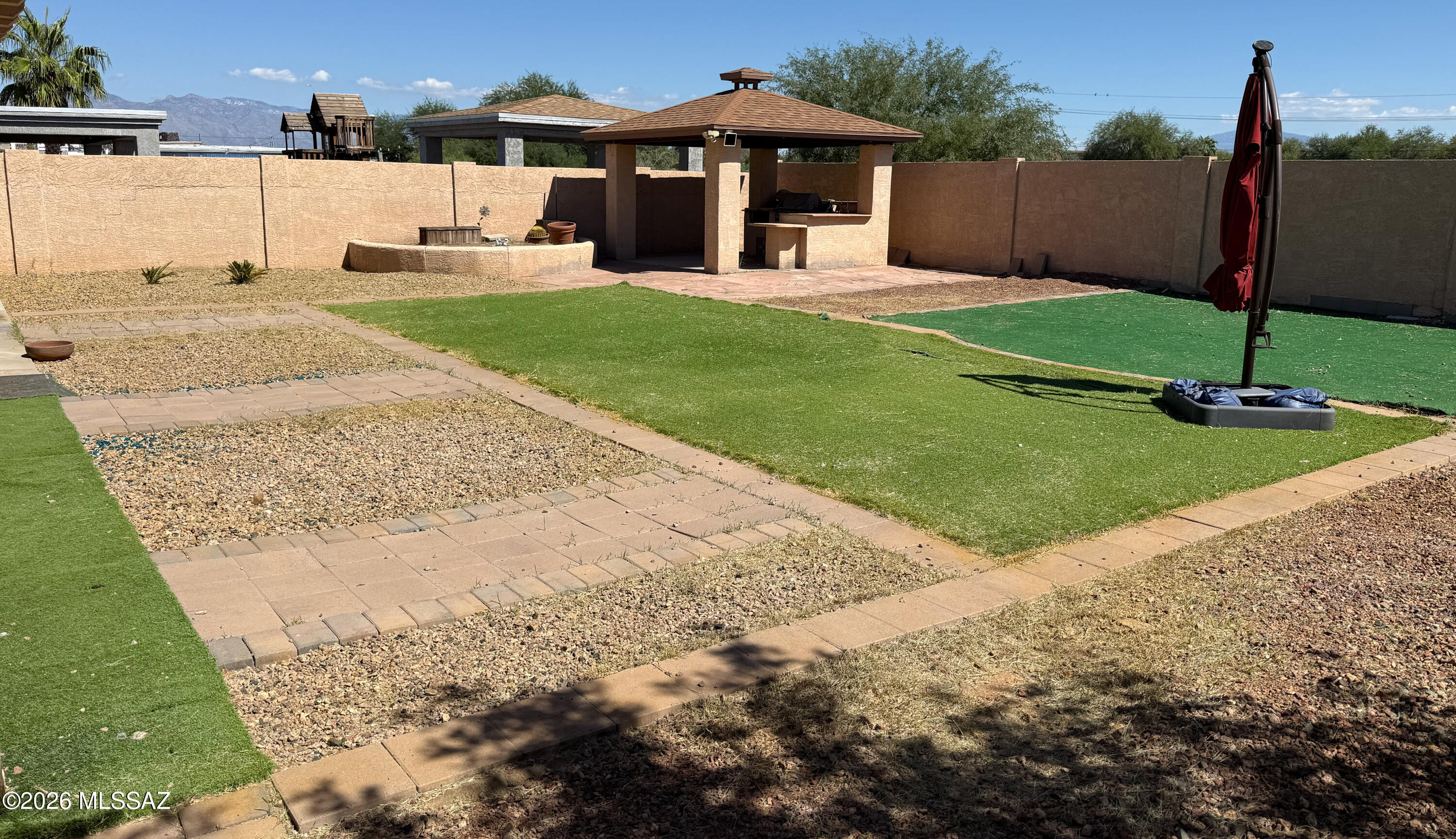 This open and versatile home has tile throughout and filled with natural light. Who needs kitchen cabinets when you have a huge walk-in pantry for storage and easy organization. Upstairs all the bedrooms are large including the primary bedroom with French doors, walk-in closet, and a private bathroom with two vanities, soaking tub and shower. Bonus room is perfect for a gaming room, den, or creative space. Huge backyard allows you to relax and enjoy or host family gathering complete with mountain views, covered patio, gazebo with built-in BBQ, and no neighbors in back. Enjoy this energy efficient home with newer Trane AC units and solar panels. Home is priced to reflect the TLC needed. Property 
being sold ''AS IS''.  Seller is a licensed Realtor in the state of AZ.
