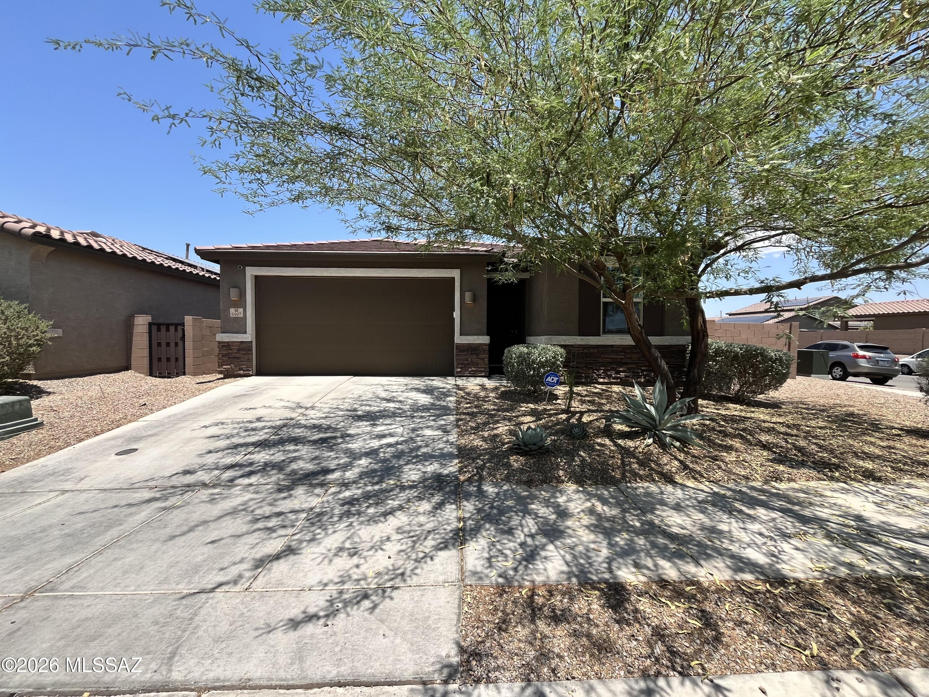 1,727 SQ FT! 4 bedroom, 2 bath home in Tucson's La Estancia Ncia De Tucson neighborhood. Desirable single-story floor plan. Charming kitchen with included appliances: Dishwasher, Dryer, Microwave, Oven, Refrigerator, and Washer. Spacious living areas, perfect for entertaining! Tile flooring in all the right places. Primary suite features a walk-in closet. This home offers 4 nicely sized bedrooms. Enjoy a backyard with a fenced yard, a grassy area, and a covered patio. 1 car garage! Located in the desirable La Estancia Ncia De Tucson community. Great Tucson location with nearby schools, parks, dining, and entertainment. Community amenities include biking/walking trails. Agents please see office remarks.