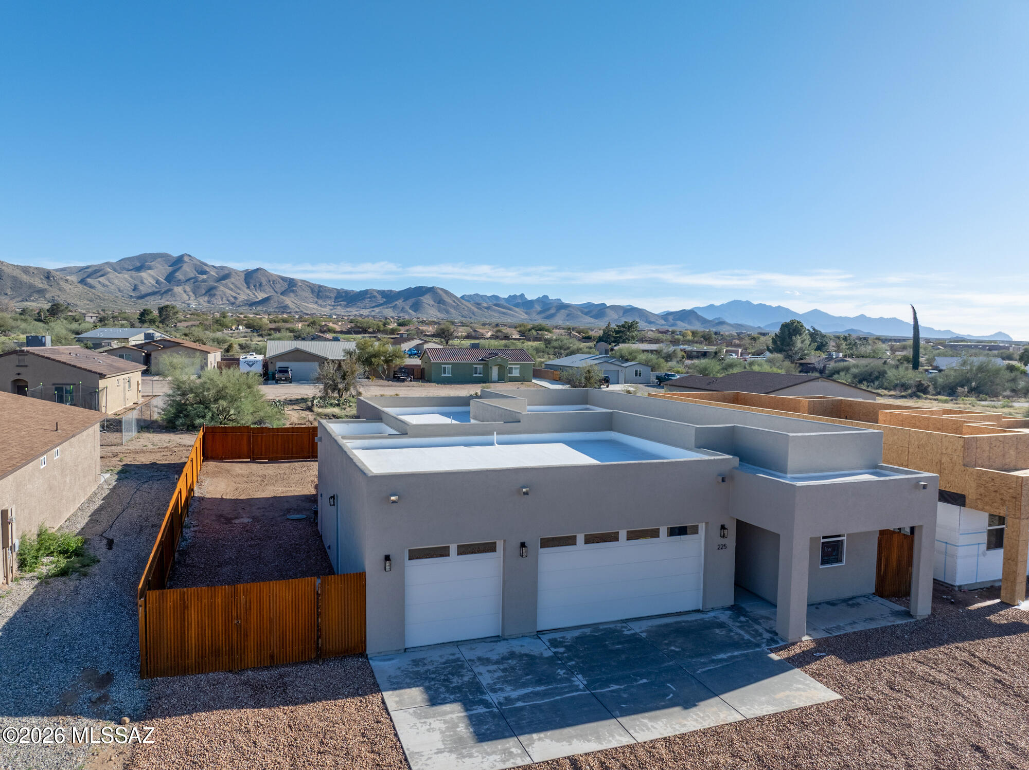 4.875% Interest rate offer! New construction in lovely and peaceful Corona De Tucson.  Look at the others and come here for quality and  upgraded options! Contemporary Santa Fe style with 3 car garage, with added temp controlled storage room in garage and so many higher upgrades you'll be impressed!  Kitchen is fully equipped with stainless steel appliances suite, an oversized island with seating and spacious pantry.  Wonderful laundry with additional storage and wash/fold area. Granite tops on all countertops.  Wood plank tile floors in all main living areas.  Wonderful Primary Suite with grand walk in shower and huge walk in custom fitted closet.  Spray foam insulation and 2x6 construction- solid and efficient.  Rustic metal fence with double gate on North side.  Front and Back covered patios, landscaped in front and a PAVED street. We have 2 additional lots that will begin construction shortly, so if you want to customize with your colors or have a special request , this can likely be accomplished! See attached flyer: This home qualifies for a limited-time lender-paid 2-1 buydown- reduced monthly payments for the first 2 years at no cost to the buyer or seller. See flyer. NO  HOA.