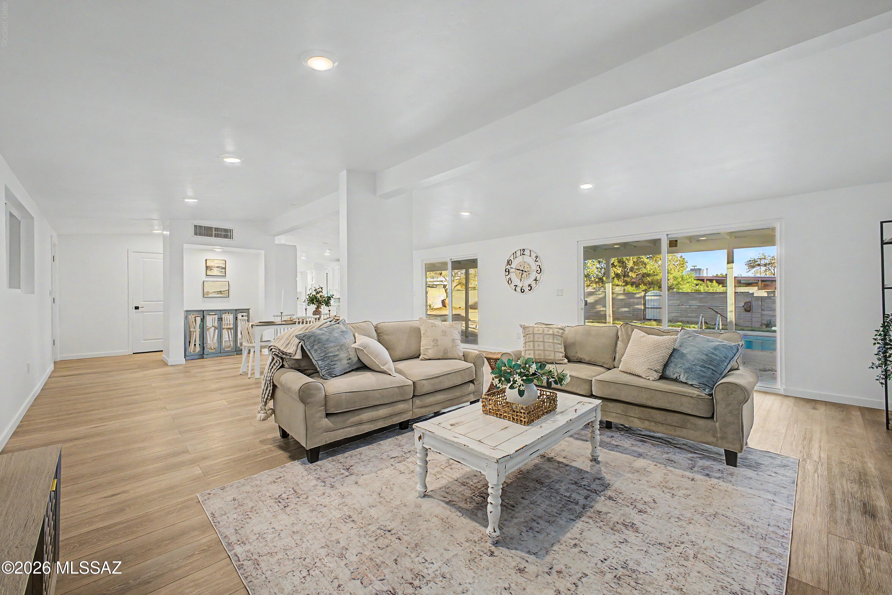 Enjoy the freedom of NO HOA, plus 0% down financing options available for qualified buyers! This beautifully renovated mid-century brick home combines timeless charm with fresh, modern finishes and the flexibility to complement any style. Inside, natural light fills the open living spaces, highlighting new flooring and a bright, neutral palette that makes decorating effortless. Step outside to your own backyard retreat featuring a sparkling pool, extended covered patio, and expansive yard perfect for entertaining, relaxing, or enjoying Tucson's beautiful weather. Conveniently located in Central Tucson, just 15 minutes from the University of Arizona and downtown, with easy access to shopping and dining.