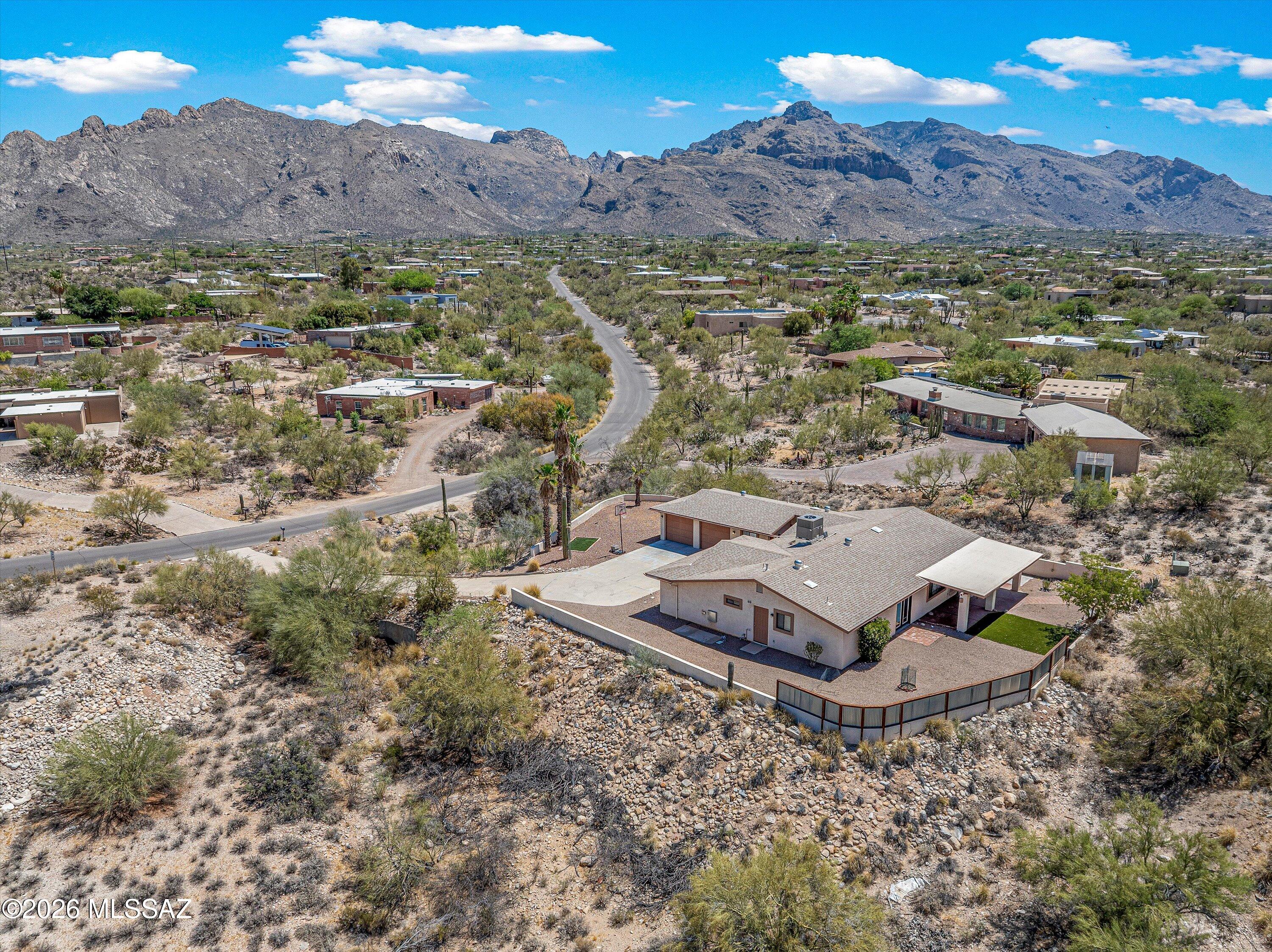 Located in the Catalina Foothills, this renovated 2,332 sqft ranch-style home blends modern updates with mountain views. A double-door entry opens to light, bright living spaces with new porcelain tile floors. The kitchen features newer stainless-steel appliances, quartz countertops, a gas range, and a decorative backsplash next to a bay window breakfast nook. The home has 4 bedrooms and 2.5 bathrooms, including a primary suite with a soaking tub, walk in shower, and a large closet. Set on a sprawling 0.82- acre lot with no HOA, the exterior offers a covered patio, artificial turf, and a water feature. It sists close to top schools, premium grocery stores, and local dining hubs