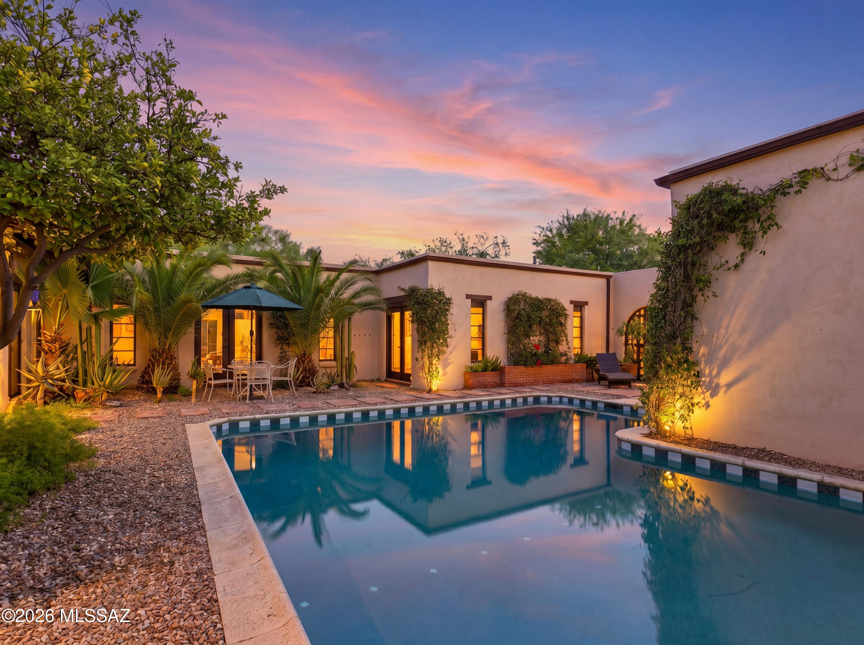 Range Price: Seller will accept or counter offers between $900,000 and $950,000.

Experience authentic hacienda living in this designer-remodeled 3-bedroom plus den estate tucked along Woodland Wash in the coveted Tanque Verde Valley. The versatile den can easily be converted into a 4th bedroom, offering flexibility for guests, a home office, or multigenerational living. Framed by breathtaking Catalina Mountain views and situated on horse property, this iconic Southwest fortress-style residence seamlessly blends historic Tucson character with sophisticated modern design.

The home's classic U-shaped hacienda floor plan embraces a stunning central courtyard, creating the ultimate indoor-outdoor living experience. At its heart is a beautifully remodeled courtyard pool surrounded by lush landscaping, offering a private oasis reminiscent of a luxury boutique resort.

Inside, rich architectural details define every space. Exposed brick walls, mortar-set brick floors, cathedral tongue-and-groove ceilings, massive wood beams, custom built-ins, and designer lighting create warmth and authenticity throughout. Walls of windows and courtyard-facing doors invite abundant natural light while framing picturesque views through the courtyard and beyond to the Catalina Mountains.

The thoughtfully remodeled kitchen is a showpiece, featuring distinctive brick countertops, a stunning apron-front copper sink, new double ovens, a new cooktop, and a new refrigerator that blend modern convenience with timeless Southwestern style. Beautifully remodeled primary and guest baths continue the home's elevated design aesthetic. A dramatic double-sided fireplace anchors both the living and family rooms, creating inviting spaces for gathering and entertaining. The spacious primary suite offers a large walk-in closet and tranquil views of the surrounding landscape.

Step outside to discover multiple outdoor living areas designed to celebrate the Arizona lifestyle. Enjoy lush grass, mature landscaping, a large covered patio, built-in BBQ, and a separate backyard Jacuzzi perfectly positioned for relaxing beneath the desert stars. Fresh exterior paint enhances the home's striking fortress-style architecture and exceptional curb appeal.

Rarely does a home capture the essence of Old World Tucson so beautifully. Rich in character, thoughtfully updated, and surrounded by unforgettable Catalina Mountain views, this exceptional hacienda offers the perfect blend of historic charm, luxury amenities, and resort-style living in the heart of the Tanque Verde Valley.