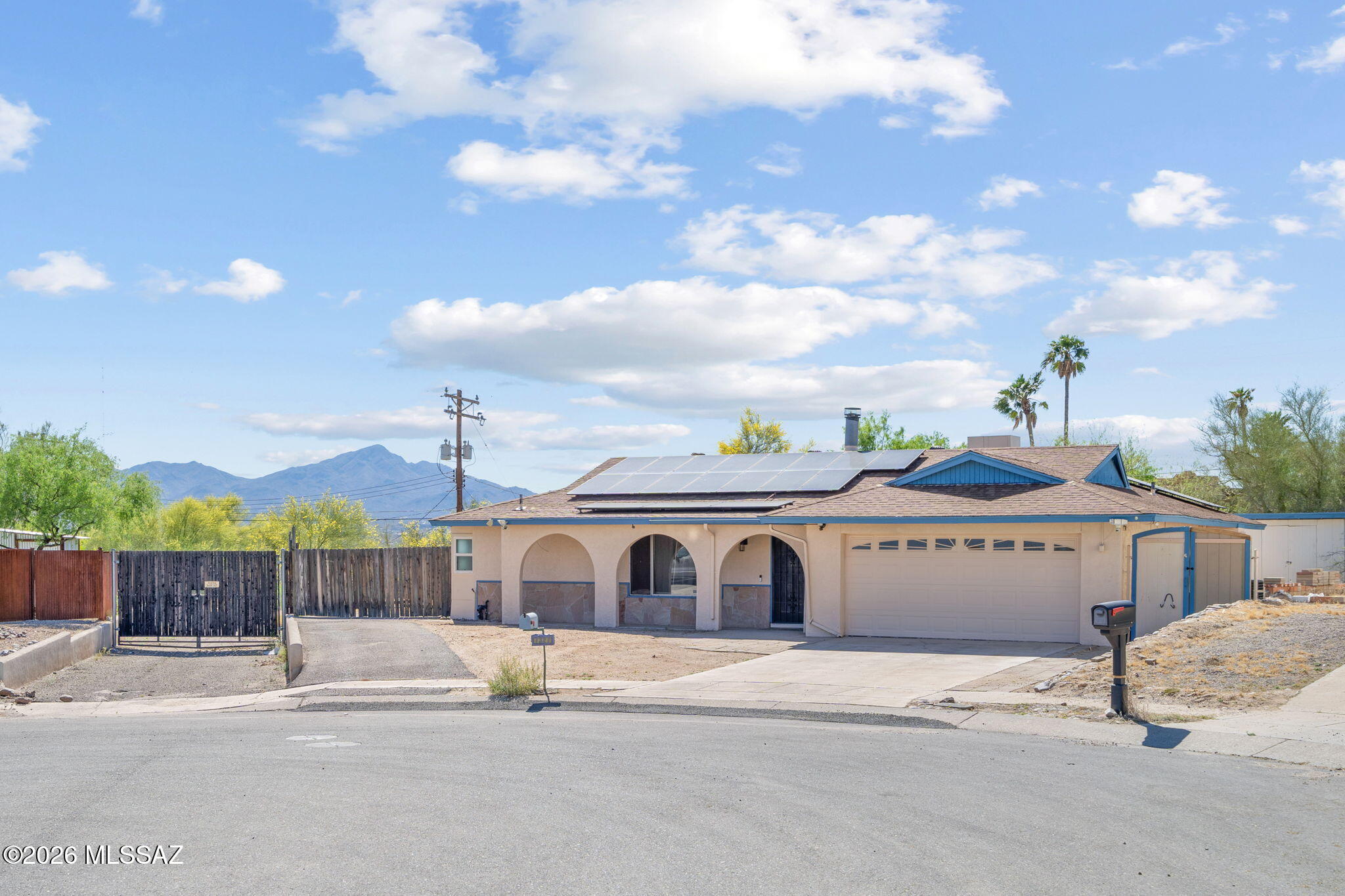 Nestled on a generous 0.27-acre cul-de-sac lot in the desirable Sunny Hills Estates, this charming 4-bedroom, 2-bath ranch-style home offers 1,933 square feet of comfortable living in the sought-after Marana Unified School District with no HOA. The inviting floor plan features both a spacious living room with a wood-burning fireplace and a separate family room, perfect for entertaining or relaxing at home. The split bedroom layout offers added privacy, while the hall bath delights with a jetted soaking tub. Ceramic tile and laminate flooring flow throughout, and the well-equipped kitchen includes a dishwasher, disposal, microwave, and trash compactor. The large fenced backyard features dual access gates - ideal for pulling in an RV, boat, or extra vehicle - along with a storage shed and a deck perfect for outdoor living. A two-car garage with an electric door opener adds everyday convenience. This move-in ready home an exceptional value. Come experience the space, character, and opportunity this Tucson gem has to offer!