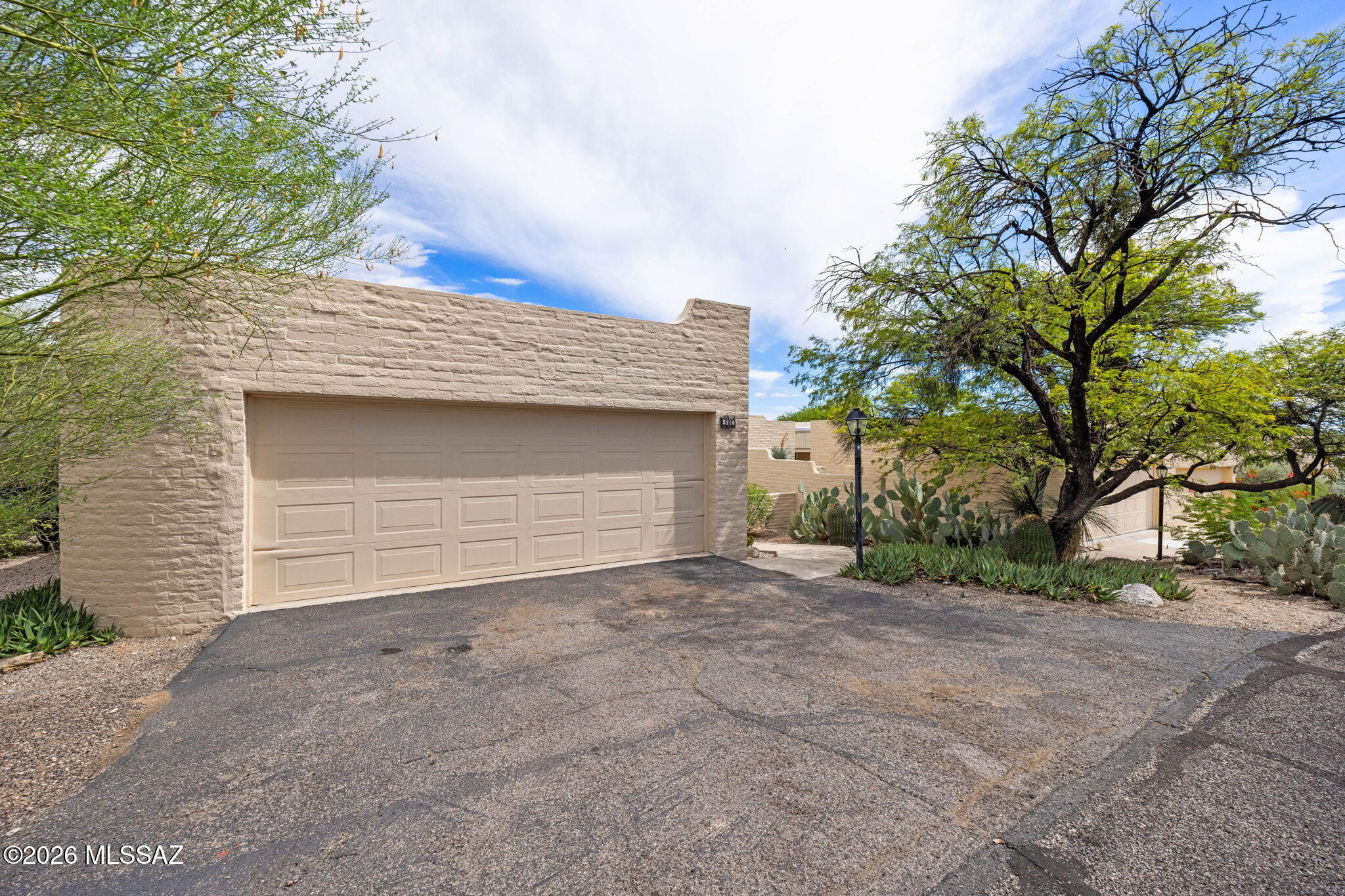 Amazing opportunity to live in the coveted Sunrise Presidio Townhomes community in desirable North Tucson! This beautifully maintained 2-bedroom, 2-bath townhome offers thoughtful upgrades, abundant natural light, and unobstructed mountain views from the backyard. A charming front courtyard entry welcomes you into the home. The remodeled kitchen features granite countertops and a wine refrigerator, while skylights brighten the interior. The inviting living area includes a wood-burning beehive fireplace, creating a warm and welcoming atmosphere. Tile flooring flows through the main living areas with carpet in the bedrooms.

The primary suite offers patio access, a spacious shower, and generous closet space. A fully permitted Arizona room adds flexible living space and opens directly to the covered back porch-the perfect place to relax and take in the stunning mountain views. The covered back porch also includes a storage room for added convenience and organization.

The laundry room offers built-in storage for household essentials. The secure 2-car garage provides covered parking, additional built-ins, and ample space for storage, tools, and recreational equipment. Enjoy community amenities including a pool conveniently located close to the home, along with tennis and pickleball courts. Ideally situated near North Tucson shopping, restaurants, everyday conveniences, and more! A rare opportunity in Sunrise Presidio - an amazing place to call home.

Owned water softener with more recently installed water heater exterior paint and roof improvements. Recent landscaping and professional cleaning completed.