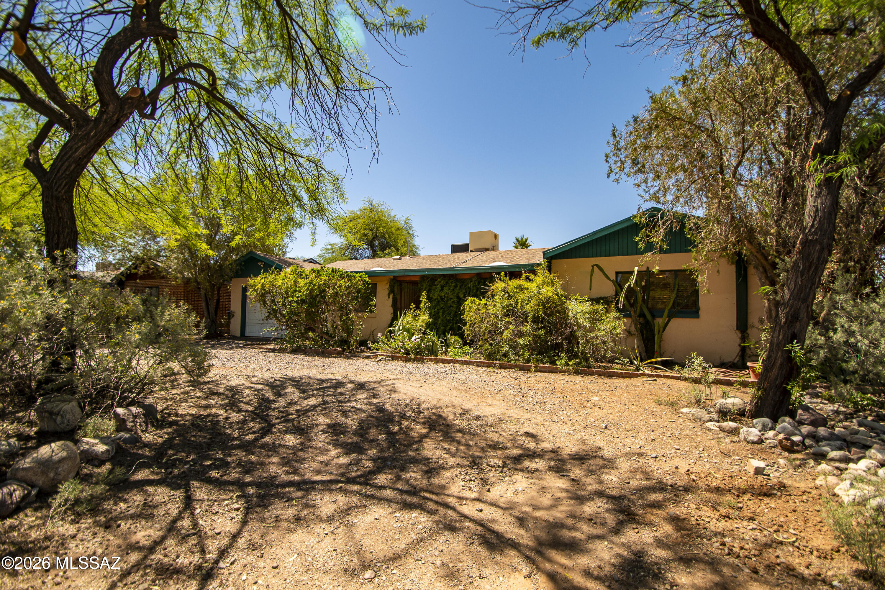 Classic 1955-built wire cut brick ranch in historic Blenman-Elm. 3 Bed/2 Bath. Open floorplan. Enormous Arizona Room with fireplace. Saltillo and carpet. Fresh paint. Spacious kitchen. Restored vintage bathrooms.  Original casement windows. The primary suite has an  extra room. Will you use it for meditating, officing, or an extravagant dressing room? The private front porch is a perfect shady green space to enjoy your morning brew. Rustic flagstone patio in the back. Lushly planted yard on drip with fruit, olive, other exotics, and some natives. Vines galore. 100 feet from the Treat Street Bikeway. A short walk to restos on Grant, and the hardware on Country Club. Bike to the U, the Loft, Coffee Times and Whole Foods. Check out the virtual tour & flythru. Call your REALTOR to see it today