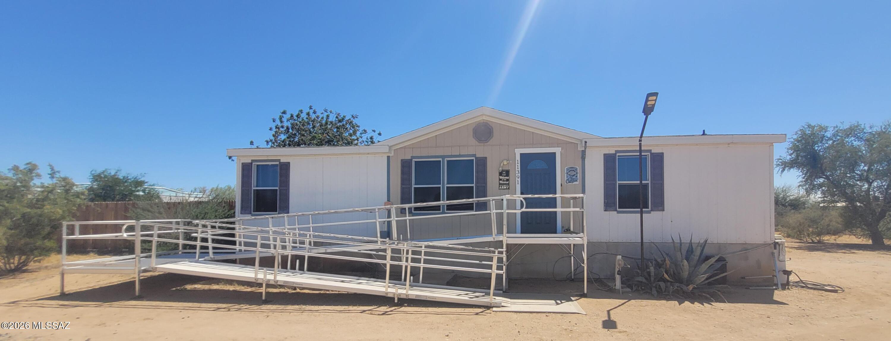 Cozy Home with LUSCIOUS backyard, dual shed and a workshop! Beautiful Views! At the end of dead end road! Private. Front automatic gate. Ramp leading up to front door! Ceramic tile, NEW KITCHEN! All appliance included! Split bedroom floor plan. Solar w/assumable loan. Stucco block skirting too!