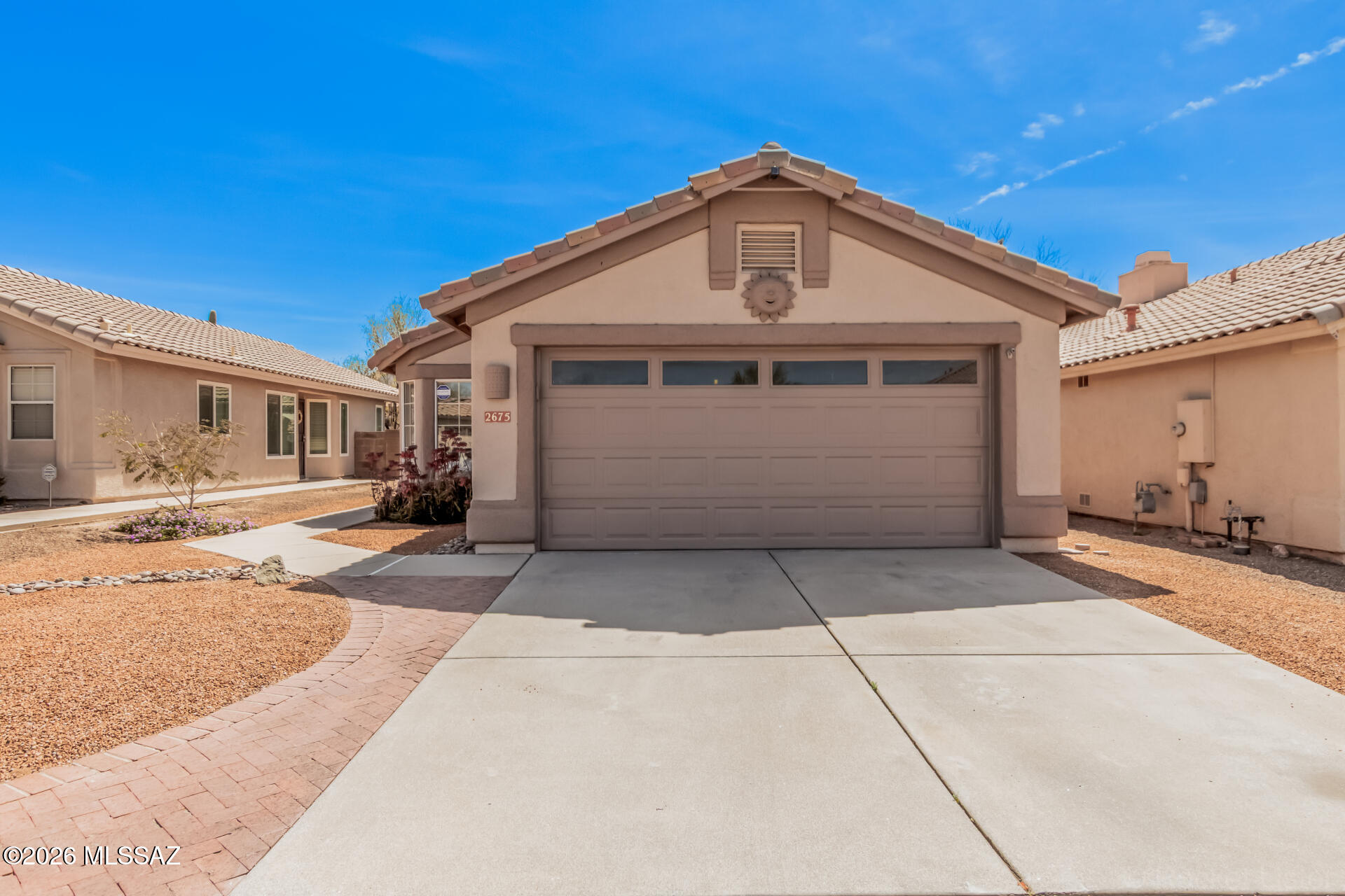 Located in the desirable NW community of Upper Bluffs, this 3-bedroom, 2-bath home offers a comfortable and functional layout with spacious living and dining areas, vaulted ceilings, and tile flooring throughout. The kitchen features a breakfast nook, ample cabinetry, stainless steel appliances, and a pantry for added storage. The primary suite includes an ensuite bath with dual sinks and a walk-in closet. The backyard is designed for easy outdoor living with a covered patio and low-maintenance turf. Just down the street, a neighborhood trailhead provides access to 100 acres of pristine Sonoran Desert, along with a community park featuring grassy picnic areas, a basketball court, and a children's play area. Conveniently located near award-winning Oro Valley schools, shopping, and More!