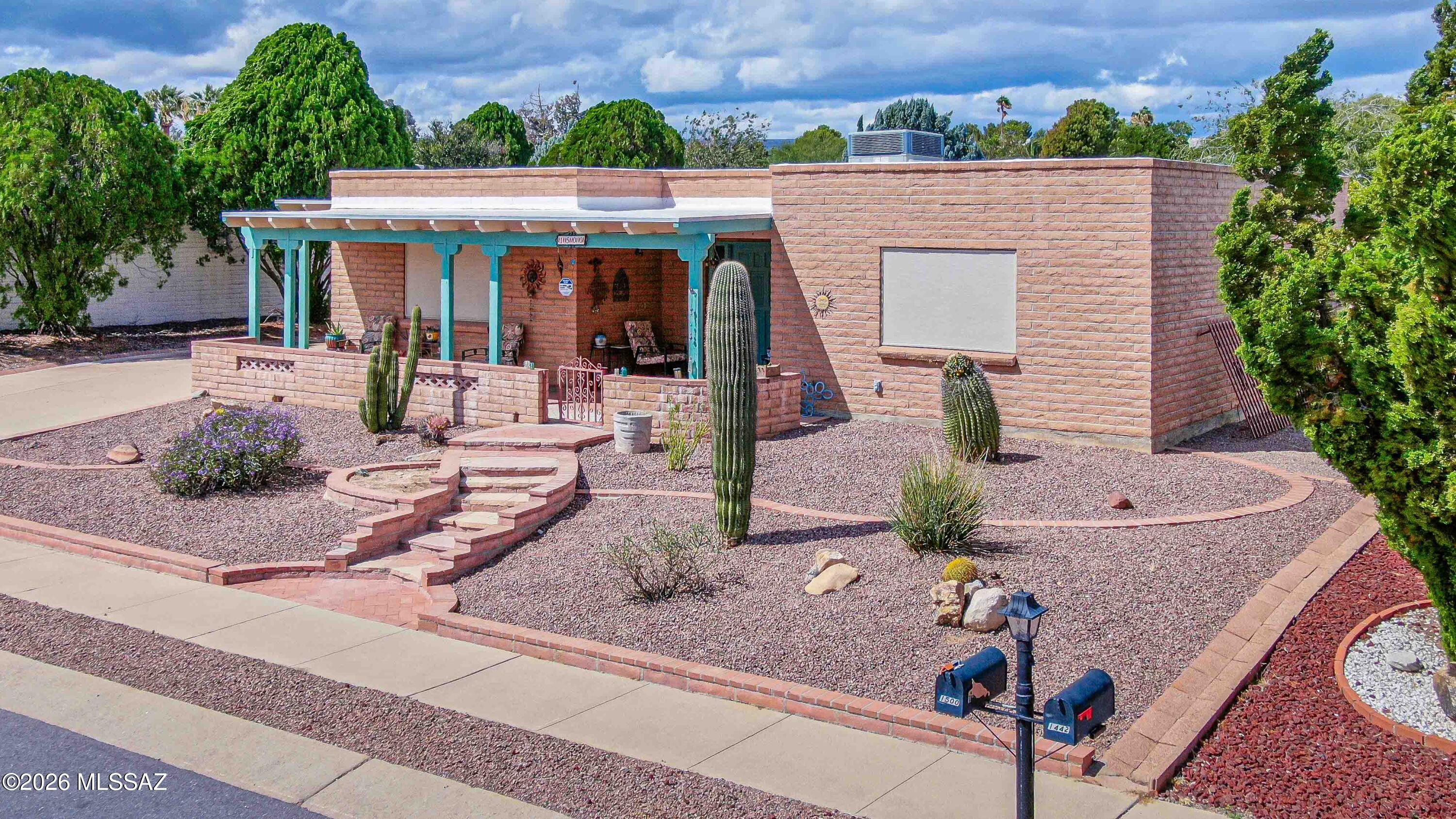 LOVELY DESERT MEADOWS HOME, SPACIOUS BACKYARD & LOW HOA!  Enjoy easy Green Valley living in this inviting 2-bedroom, 2-bath home with an enclosed Arizona room, a generously sized backyard, and an incredibly low HOA fee of just $20 per year! Whether you're looking for a year-round residence or an Arizona getaway, this home offers comfortable living, flexible space, and a fantastic location. Great curb appeal welcomes you with low-maintenance desert landscaping, flagstone accents, and a shaded front porch with partial Santa Rita Mountain views, a perfect spot to enjoy your morning coffee.  A 1-car carport plus additional parking for a second vehicle provides added convenience. Inside, the spacious living room features ceramic tile flooring that extends throughout the main living areas and flows seamlessly into the dining area and remodeled kitchen. The kitchen offers granite countertops, abundant cherry cabinetry, and a large breakfast bar perfect for casual dining or entertaining. Need a little extra space? The enclosed Arizona room offers  flexibility for a home office, hobby room, reading retreat, or creative space.   The owner's bedroom has two closets for generous storage and a beautifully remodeled en-suite bath featuring a stylish tiled walk-in shower. Step outside to the large, low-maintenance backyard, where you'll find plenty of room to garden, entertain, relax in the Arizona sunshine, or create your own outdoor retreat. Additional highlights include a recently serviced HVAC system for added peace of mind and a dedicated laundry room with washer and dryer included. Conveniently located near shopping, restaurants, the post office, and easy access to I-19. Green Valley Recreation (GVR) offers an impressive array of amenities and activities, including fitness centers, swimming pools, pickleball courts, classes, movies, shows, and much more. Located in an age-restricted 55+ community, this Desert Meadows 2 home is ready to enjoy as a year-round residence or seasonal Arizona retreat!