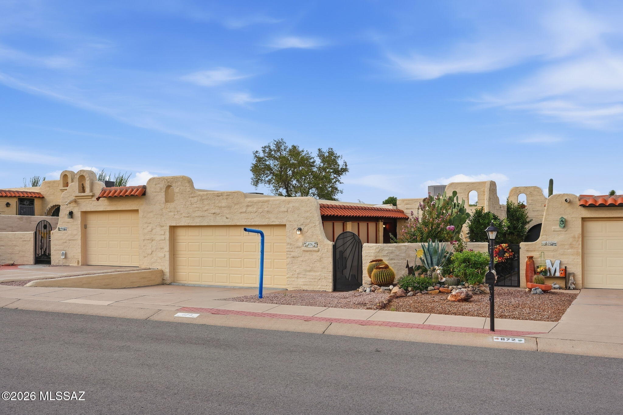 Inspired by classic Spanish Colonial architecture, this distinctive Earl Whigham home blends old-world elegance with relaxed Southwestern living.  Richly textured stucco exterior walls, a red clay tile roof, graceful arched windows and doorways and handcrafted architectural details give the home exceptional warmth, character and timeless appeal. Inside, Spanish tile and richly textured finishes continue the architectural story, creating inviting living spaces filled with authentic Southwestern charm.  A covered patio and courtyard with a retractable louver sunscreen extend the living areas outdoors, providing   comfortable shaded spaces ideal for entertaining family and friends, relaxing in the open air or simply enjoying the surrounding desert landscape. Rooted in centuries-old