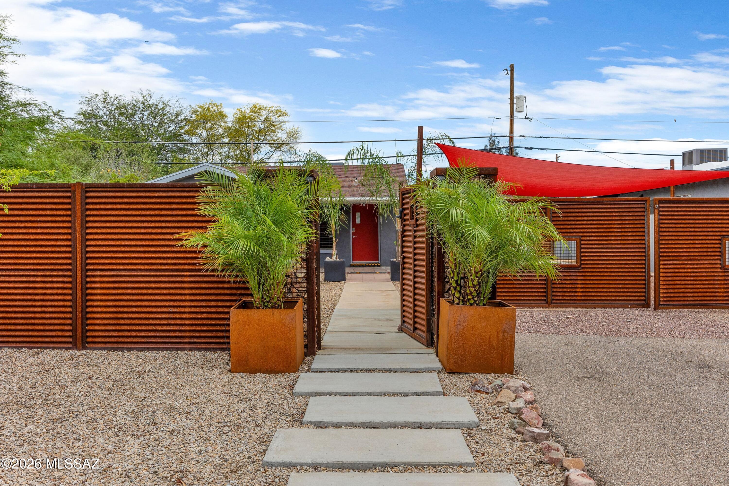 Beautifully reimagined 1943 Tucson gem that retains its mid-century charm while delivering every modern luxury! The fully renovated chef's kitchen impresses with sleek finishes, a dedicated wine refrigerator, and separate freezer -- perfect for entertaining. Both baths have been fully updated, and stylish new lighting elevates every room. Unwind by the new electric fireplace in the living room or host al fresco dinners with the gas grill plumbed directly to the natural gas line. Peace of mind comes easy with recently replaced HVAC system and tankless water heater. The fully enclosed property delivers privacy and security with an electric vehicle gate and keyless walkthrough gate. All furniture available by separate bill of sale -- a true turnkey treasure!