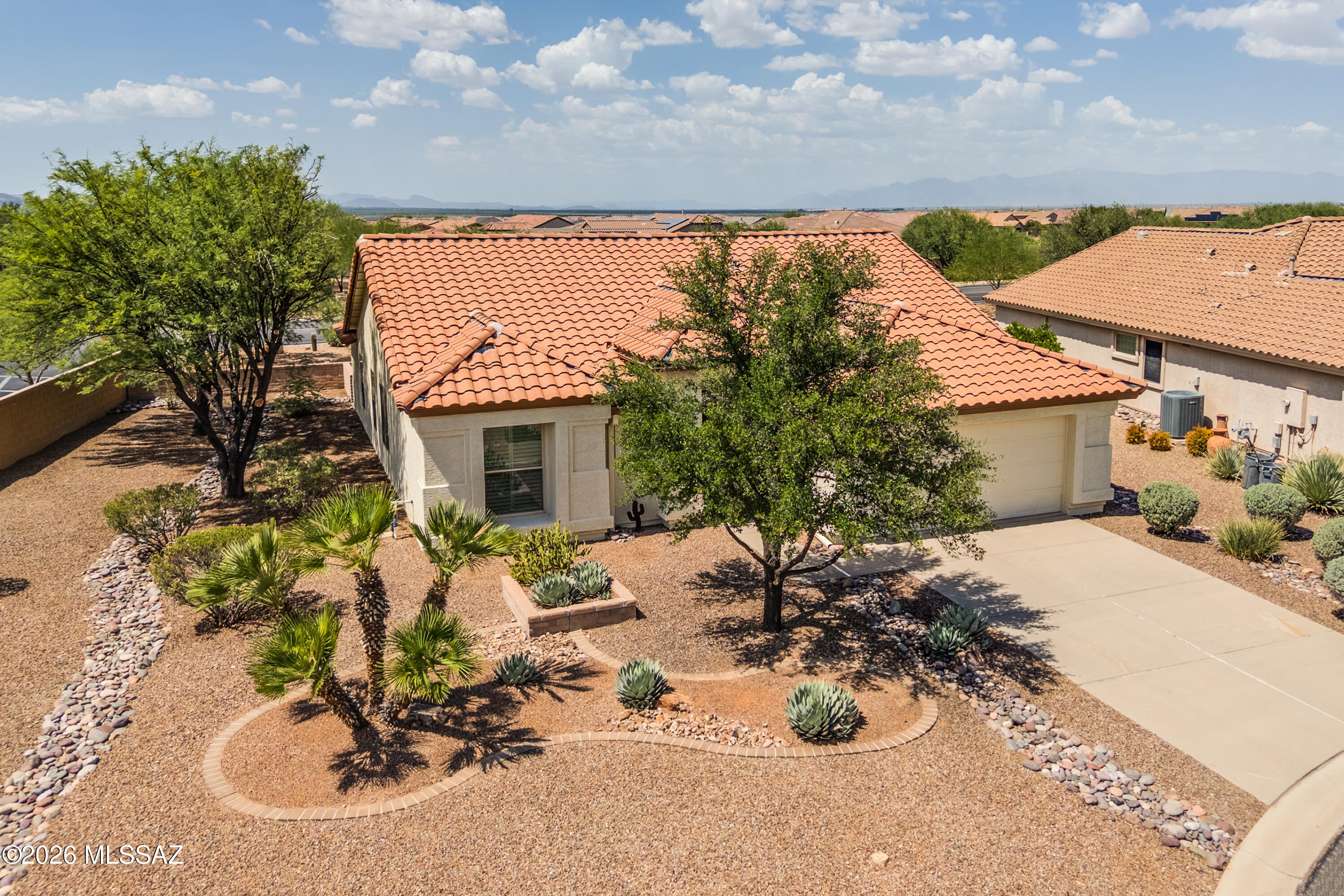 Offered fully furnished and move-in ready, this beautifully maintained 1,432 sq. ft. Augusta model is tucked away on a peaceful cul-de-sac in Quail Creek. Featuring 2 BR, 2 BA and a versatile den, this home is set on a rare, premium extra-wide lot .22 acre lot with mature trees for exceptional privacy. Inside, the spacious great room is filled with natural light and complemented by tile flooring in the main living areas and plantation shutters throughout. The fully remodeled kitchen features 41-inch upper cabinets, granite counters, tile backsplash, GE Profile slate appliances, gas range, and a large island with wine storage. A built-in buffet provides additional storage and serving space, while the dining area features a bay window and comfortably accommodates seating for six. The owner's suite features a slider to rear patio, generous walk-in closet and remodeled bath with a dual vanity, granite counters, undermount sinks and a walk-in shower. The split-bedroom floor plan provides welcome privacy for owners and guests; the guest bedroom is conveniently located near a guest bath with a jetted tub, while the den offers flexible space for a home office, quiet nook or hobbies.

Outside, an extended paver patio, lush desert landscaping and a gas stub for a barbecue create an inviting setting for relaxing and entertaining. The premium extra-wide lot offers exceptional possibilities, including space for a casita, workshop or golf cart garage. Additional highlights include a roof replaced in November 2019 and a two-car garage with epoxy flooring and built-in storage cabinets. Best of all, the home is conveniently located near Quail Creek's golf, dining, clubhouses and extensive amenities, making it easy to enjoy the community's exceptional resort lifestyle.