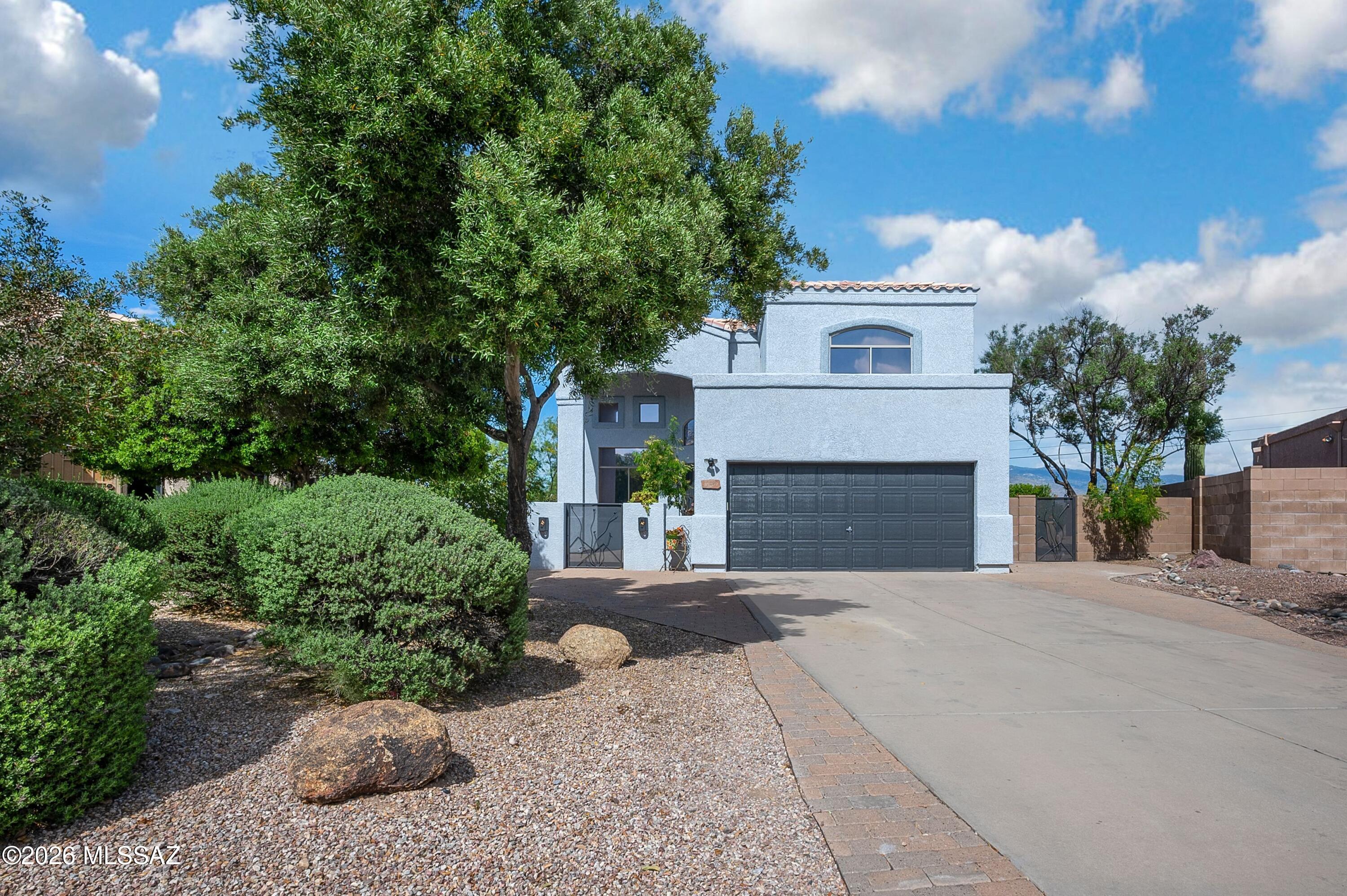 Stunning 5 BR, 3 BA masonry stucco home in Tucson's sought-after Rita Ranch on a generous 10,753sq ft corner lot. Welcoming courtyard entry with brick pavers leads into a bright two-story layout with soaring ceilings, dramatic staircase, and multiple living spaces for flexibility and comfort. Deluxe kitchen with granite island, gas cooktop & SS appliances. The backyard is a desert oasis featuring: sparkling pool & spa, fire pit, mature landscaping and huge side yard. An entertainers' delight with majestic mountain views. Upstairs, the primary suite offers a balcony with sweeping desert and sunset views. Updated primary bath includes a walk-in shower with dual shower heads and designer tile. Recent upgrades include freshly painted inside & out, Plus Rheem 3 ton AC installed 9/2025