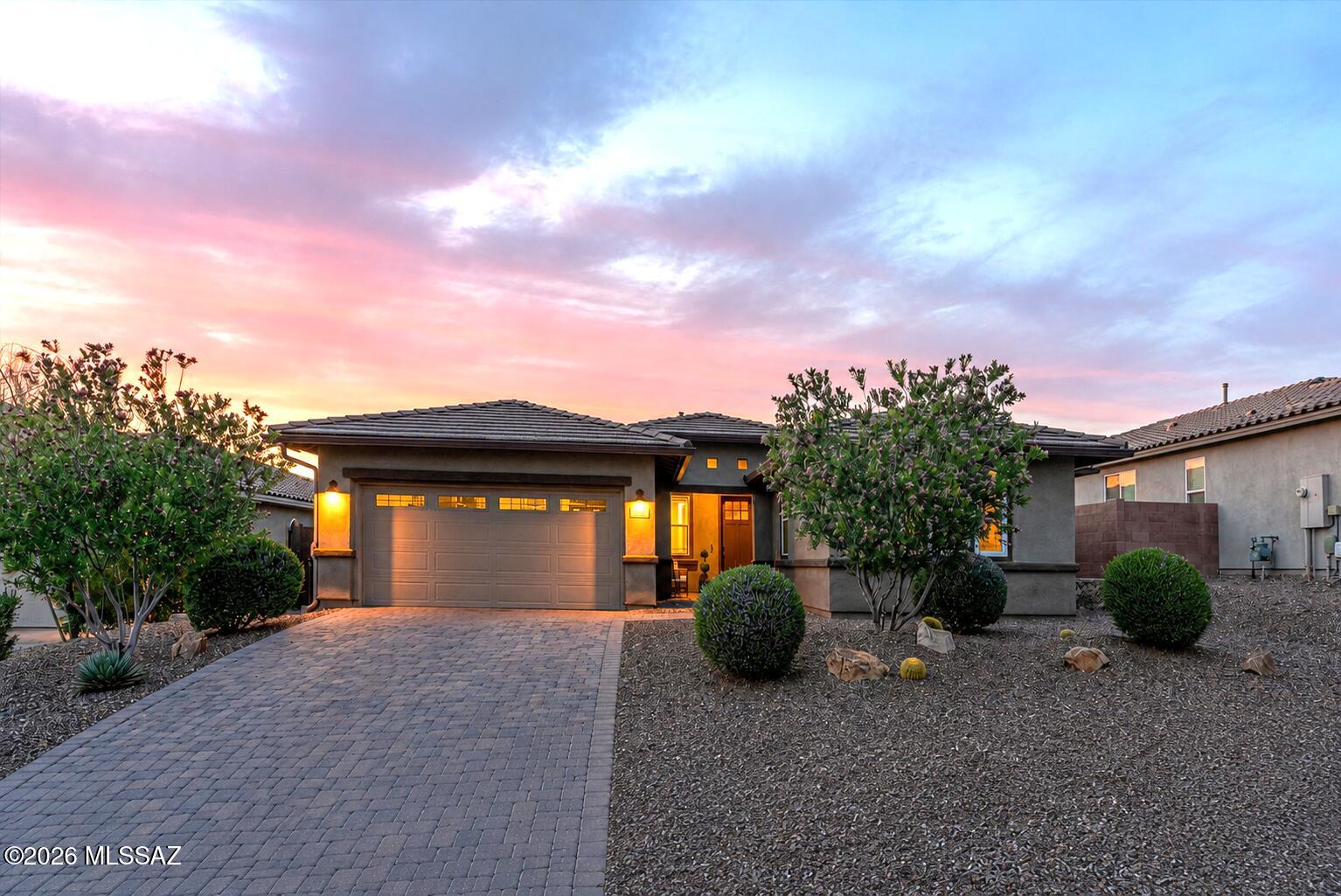 Sophisticated style and understated refinement define this exceptional Blue Agave residence in Dove Mountain's acclaimed master-planned community. Better than new and meticulously maintained, this 2,519 sq. ft. Ridgeview plan offers 4 bedrooms, 2.5 baths, a versatile den/office/media room, and a tandem 3-car garage.

Situated on premium Lot 133 with a builder lot premium, the home features an upgraded front elevation, paver driveway, and entry walkway. Inside, abundant natural light, a neutral designer palette, updated lighting and ceiling fans, and upgraded 8-foot interior doors create an inviting atmosphere throughout.

A flexible den with elegant double 12-lite French doors and sidelites provides the perfect space for a home office, media room, playroom, study, or potential 5th bedr Main living areas, hallways, powder room, and bathrooms showcase upgraded Hill House Natural wood-look porcelain tile in a 6x36 format, installed in a premium stair-step pattern with rich walnut grout.

The spacious great room, dining area, and kitchen flow seamlessly together, creating an ideal setting for everyday living and entertaining. Custom cabinetry adds architectural interest and valuable storage. The chef-inspired kitchen features an upgraded structural layout, grand center island, top-tier appliances, reverse osmosis filtration, abundant cabinetry, built-in desk area, breakfast nook, designer lighting, sleek backsplash, Kohler Cairn matte black undermount sink, and Arbor oil-rubbed bronze faucet.

Oil-rubbed bronze plumbing fixtures and Moen Eva series faucets continue throughout the home, creating a cohesive and timeless aesthetic.

The split-bedroom floor plan provides privacy, with three secondary bedrooms featuring upgraded Level 3 Sumptuous Cashmere carpeting and premium 8-pound Vessel padding. The hall bath offers floor-to-ceiling tile at the tub and shower along with dual vanities.

The primary suite is a peaceful retreat with mountain views, abundant natural light, spacious proportions, and a spa-inspired bath featuring an oversized tiled walk-in shower with matching tile floor, spa niche, dual vanities, and a large walk-in closet.

Additional highlights include a spacious laundry room with sink, stylish half bath, and mudroom area adjacent to the tandem 3-car garage.

Outdoor living is equally impressive with a custom travertine patio, inviting fire pit, artificial turf, extensive covered patio with epoxy flooring, natural gas grill connection, and view fencing that showcases the surrounding desert landscape and spectacular Arizona sunsets.

Practical upgrades include whole-house surge protection, a structurally installed 110-volt floor outlet in the great room, water softener, and gutters.

Residents enjoy the exceptional Dove Mountain lifestyle, surrounded by the Tortolita Mountains and Sonoran Desert. Community amenities include miles of hiking, biking, and walking trails, world-class golf, luxury resort experiences, fine dining, wellness opportunities, abundant wildlife, dark-sky views, parks, open space, and convenient access to shopping, healthcare, dining, and major transportation routes.

Families benefit from access to Marana's highly sought-after Dove Mountain CSTEM K-8 School, offering a hands-on focus in computer science, technology, engineering, and mathematics.

Combining thoughtful upgrades, flexible living spaces, premium finishes, and an exceptional location, this remarkable Blue Agave home presents a rare opportunity to enjoy refined desert living in one of Marana's most desirable communities.