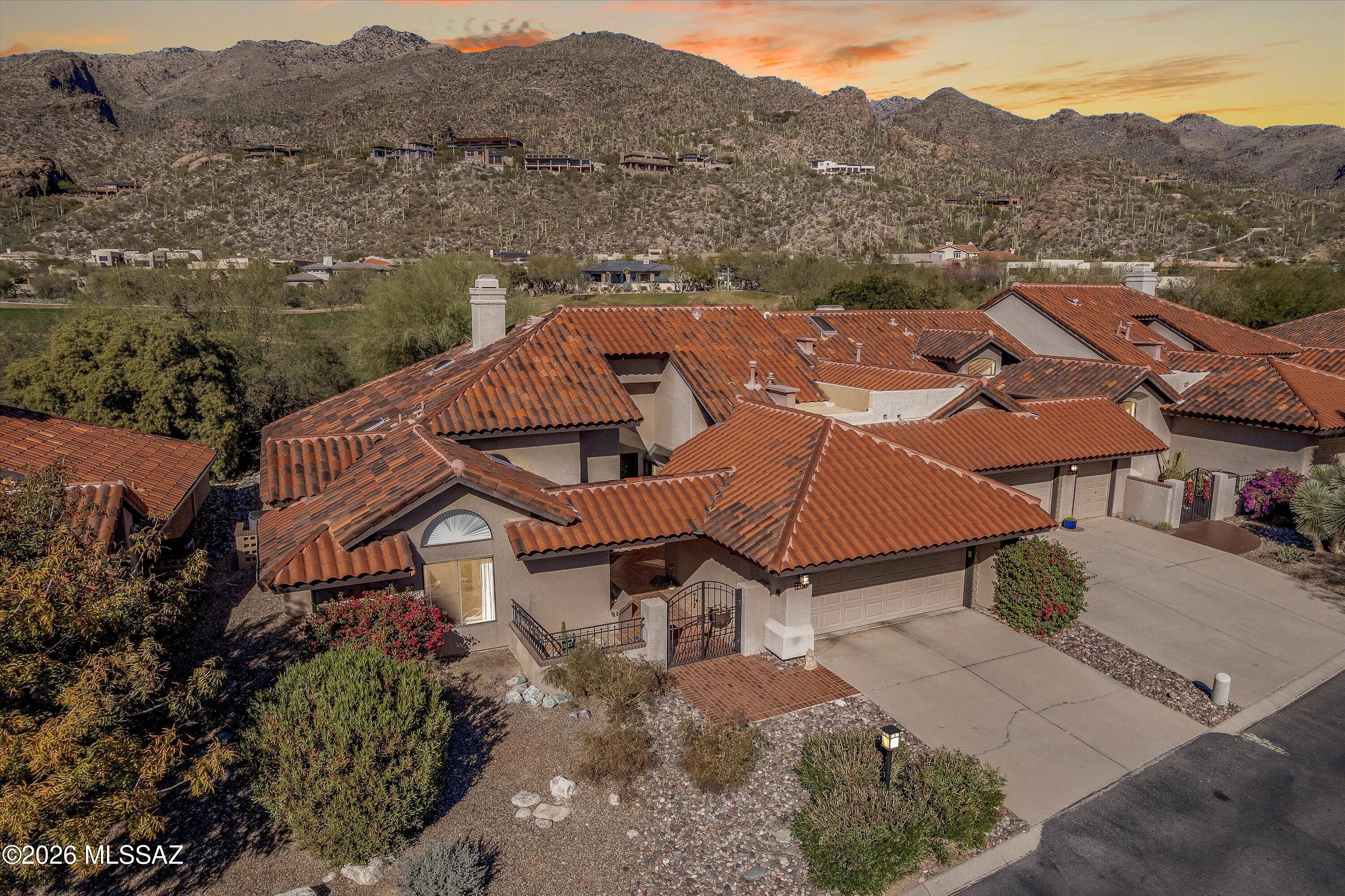This home was reimagined and renovated two years ago, not to ''flip,'' but to be the owners' perfect forever home. Then one unexpected opportunity arose, and this exceptional residence is now available. This single-level, two-bedroom home with an office and two spa-inspired baths offers 2,270 square feet of refined Mediterranean living within the Lake Estates enclave of guard-gated Ventana Canyon. A comprehensive renovation elevated the home throughout with quartz countertops, custom soft-close cabinetry with luxury pull-outs, Bosch appliances, engineered hardwood floors, and designer lighting. The kitchen is flanked by a dining room on one side and a large den/library/casual eating area on the other, adding flexibility and function. Outdoors, enjoy an exercise pool with resistance jets. Catalina Mountain views, exceptional privacy, smart home features, and the rare "All-In Insurance" HOA complete this sophisticated offering.
This home was reimagined and renovated two years ago, not to "flip," but to be the owners' perfect forever home. Then one unexpected opportunity arose, and this exceptional residence is now available.
Set within the Lake Estates enclave of guard-gated Ventana Canyon, this single-level Mediterranean home offers 2,270 square feet of refined living where light, privacy, and thoughtful design converge.
The renovation honored the home's original architectural character while elevating both form and function throughout. Custom wrought iron entry doors with integrated screened panels create a striking arrival and allow fresh desert air to circulate during Tucson's most beautiful seasons.
Inside, natural light fills the home bright yet gentle, never harsh  achieved through thoughtful orientation, plantation shutters, and double-pane windows. Engineered hardwood floors installed during the renovation run through the main living areas, adding warmth and continuity while providing an ideal backdrop for art and furnishings.
THE KITCHEN
The kitchen was comprehensively redesigned with quartz countertops, a full-height backsplash, and custom soft-close cabinetry throughout. Luxury pull-out shelving, specialty knife and utensil drawers, under-cabinet lighting, and carefully selected designer bar lighting reflect the level of intention behind every detail. Bosch appliances deliver professional-grade performance in a refined, integrated design.
DEN / LIBRARY / CASUAL EATING AREA
Off the kitchen is a versatile den/library and casual eating area, generously sized to function comfortably as all three. This flexible space enhances everyday living, allowing for reading, conversation, informal meals, or work-from-home needs while remaining connected to the heart of the home.
DINING ROOM
The kitchen also opens to a dedicated dining room. An Abbie chandelier lights the room.
OFFICE
The office, positioned off the foyer, has generous space for two desks and is easily configurable for office equipment. French doors open for light or close for privacy.
BEDROOMS & BATHS
The split floor plan ensures privacy, with the primary suite occupying its own wing. The primary bath has been fully reimagined with quartz countertops, custom cabinetry, dual shower heads, a Toto washlet, and a generously sized closet. The guest bedroom is well-proportioned and located near a beautifully renovated second bath with matching finishes and quality craftsmanship.
OUTDOOR LIVING
Outdoor living is anchored by a private exercise pool with resistance jets, allowing for swimming in place or relaxed enjoyment with the jets turned off. The backyard offers partial golf course views, Catalina Mountain vistas, and an exceptional sense of privacy. Landscaping and exterior lighting were redesigned and installed in 2025, enhancing both ambiance and functionality.
ADDITIONAL FEATURES
Additional improvements include a new water heater with circulation pump for instant hot water, smart home controls for the thermostat, front door lock, and pool heater, new rear doors and fixed glass panes, ceiling fans with remote controls, and updated fixtures throughout.
Lake Estates is an intimate community of just 47 homes, known for its welcoming atmosphere, monthly gatherings, and the highly desirable "All-In Insurance" HOA structure (buyer to independently verify coverage details).
Offering single-level living, two bedrooms plus a den/library, a two-car garage, and proximity to Ventana Canyon Country Club, hiking trails, and Catalina Foothills shopping and dining, this home delivers a rare blend of comfort, sophistication, and livability.
