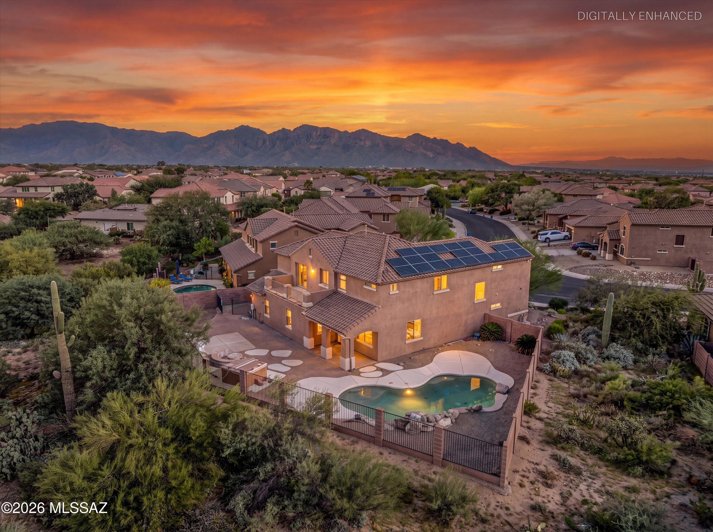 Discover luxury desert living in this stunning, expansive two-story 3,371 SF home in the desirable gated community of Tangerine Crossing, where breathtaking views, exceptional indoor-outdoor living, and an ideal location come together. Featuring 5 bedrooms, 5 bathrooms, and a versatile downstairs en suite den ideal for a home office, guest retreat, or potential multigenerational living space, this home offers the perfect blend of comfort, flexibility, and functionality.
The spacious backyard is designed for entertaining, complete with a sparkling pool, built-in BBQ, and inviting flagstone seating surrounding a cozy firepit--perfect for enjoying Arizona's beautiful evenings and spectacular desert sunsets. Situated on a premium perimeter lot backing to open desert, the property captures panoramic views of the majestic Tortolita Mountains. A natural desert buffer between the home and the western neighbor enhances the sense of privacy while preserving the beautiful Sonoran Desert surroundings. A large gated side yard offers additional versatility, with space for a garden, outdoor hobbies, or a dedicated area for four-legged companions.
A rare four-car garage with an EV charger provides ample room for vehicles and storage. Residents of Tangerine Crossing enjoy the added benefits of a gated community with multiple pocket parks, offering inviting green spaces to enjoy the outdoors. Conveniently located near shopping, dining, recreation, and everyday amenities, this exceptional home combines generous living spaces, thoughtful features, and spectacular desert scenery in one remarkable Arizona lifestyle opportunity.