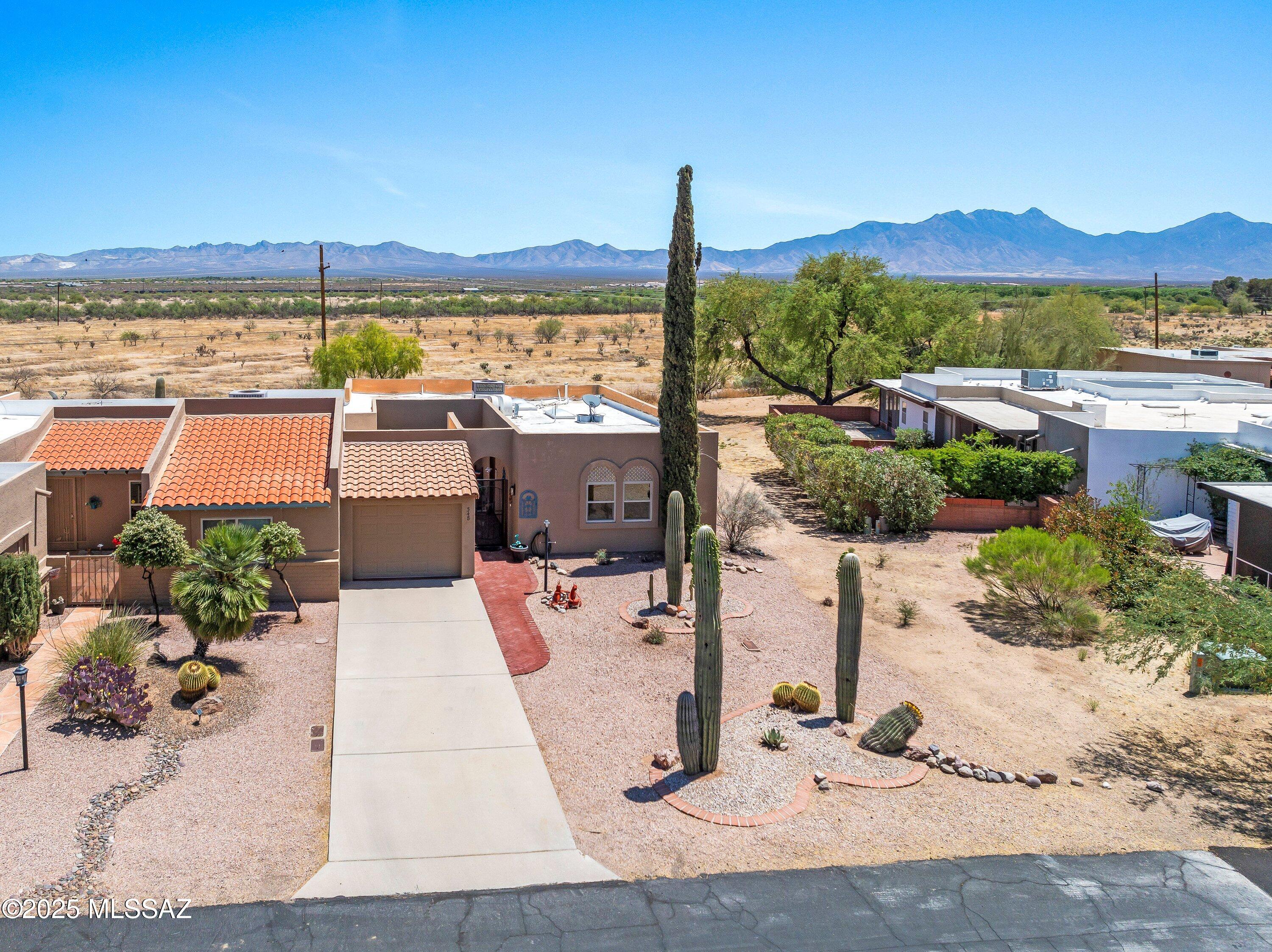 Looking for a Townhome with a panoramic Mountain view?  Large back yard space, attached garage & front courtyard!  Nestled in the desirable Green Valley Country Club North neighborhood!  This end unit has plenty of windows allowing a lot of natural light, move in ready, open kitchen to dining area and  living room.  Laundry-room with storage, washer & dryer included!  Kitchen appliances stay, large skylight in kitchen, breakfast bar & plenty of cabinets! Den/TV room located in the rear off of the Main Suite, has sliders to the covered patio!  Large bedrooms, plenty of closet space, Interior courtyard with room for entertaining.  In 2026 roof re-coated, 2018, new hot water heater, 2018 new HVAC, 2020, new windows except 2 BR. Has GVR!  Great desert landscaping w/ Saguaro's!