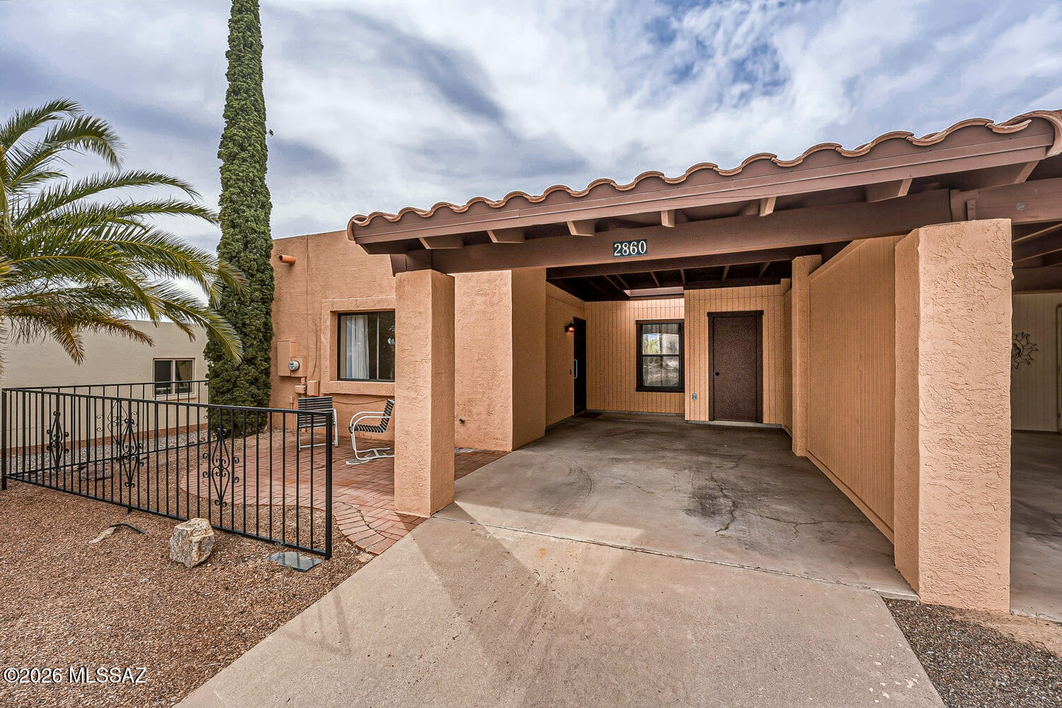Enjoy easy, relaxed living in this inviting  2-bedroom, 2-bath end-unit townhome with beautiful mountain views from both the living room and front patio. Fresh, neutral tones and updated windows create a bright and welcoming feel throughout. The spacious living and dining area features attractive laminate wood flooring, offering a comfortable space to relax or entertain. The Arizona room adds valuable bonus space, perfect for a home office, hobby room, or cozy retreat and includes a sliding door that opens to a peaceful backyard facing a common area with no direct neighbor behind, allowing you to enjoy quiet desert views. The owner's bedroom offers a double closet and an ensuite bath with a walk-in shower. Additional highlights include a 1-car carport, a spacious pantry, and two storage closets, offering abundant extra storage throughout.  Washer and dryer are included for added convenience. Tucked away on a quiet street, yet just minutes from Green Valley Recreation amenities, including pools, fitness centers, classes, and more. Whether you're looking for a winter getaway, full-time home, or investment opportunity, this one is not to be missed!