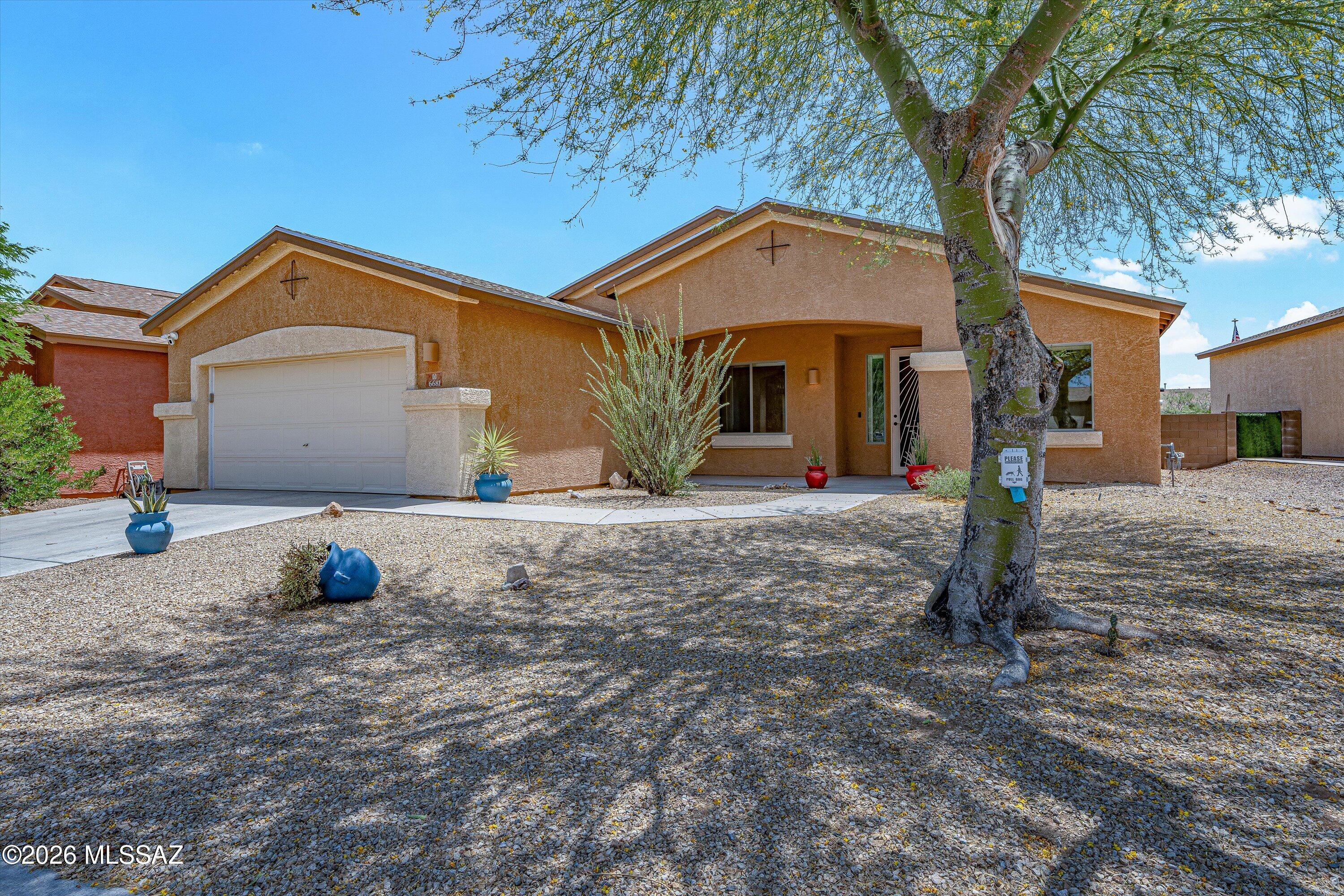 Welcome to Sonoran Ranch Estates -- Space, Style & Stunning Views! 
This beautifully designed 3-bedroom, 2-bath single-family home (WITH A NEW ROOF AND AC) offers 1,945 sq ft of open-concept living on a generous 7,632 sq ft lot. Built in 2005, the layout flows seamlessly from the formal dining room into the spacious living area, with the kitchen and breakfast nook anchoring the back of the home. The kitchen features an island with breakfast bar seating, coordinating cabinetry and countertops, and all appliances included. The private primary suite opens to backyard views and boasts a luxurious bath complete with garden tub, separate enclosed shower, extended vanity, and a large walk-in closet. Two additional bedrooms are thoughtfully positioned on the opposite side of the home for added privacy.
Enjoy low-maintenance desert landscaping in front, a covered patio, and a 2-car garage with a large utility room. Nestled in the desirable southwest Tucson corridor with easy access to major routes -- this one checks all the boxes!