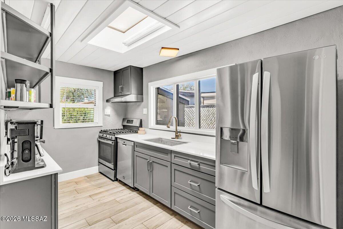 This inviting residence offers a comfortable footprint with thoughtful updates and easy access to nearby amenities in the heart of central Tucson.
Inside, the home features tile floors (no carpet) throughout, along with new windows that bring in natural light and improve efficiency. Wood plank ceilings and an accent wall of wood and acoustic panels create warmth and visual interest. The kitchen is updated with quartz countertops, stainless steel appliances including a dishwasher, a gas range, and a pantry cabinet for added storage. A skylight adds additional brightness, enhancing the home's fresh feel.
The layout includes an updated bathroom with a walk-in shower, new vanity, and linen closet. A spacious laundry room adds functionality and the washer and dryer convey, adding everyday convenience.
Outdoor living centers around a brick paver patio and hot tub, creating a private space to relax or unwind at the end of the day.
With its fantastic location and practical updates, this home offers a well appointed, low-maintenance option in one of Tucson's most convenient areas.