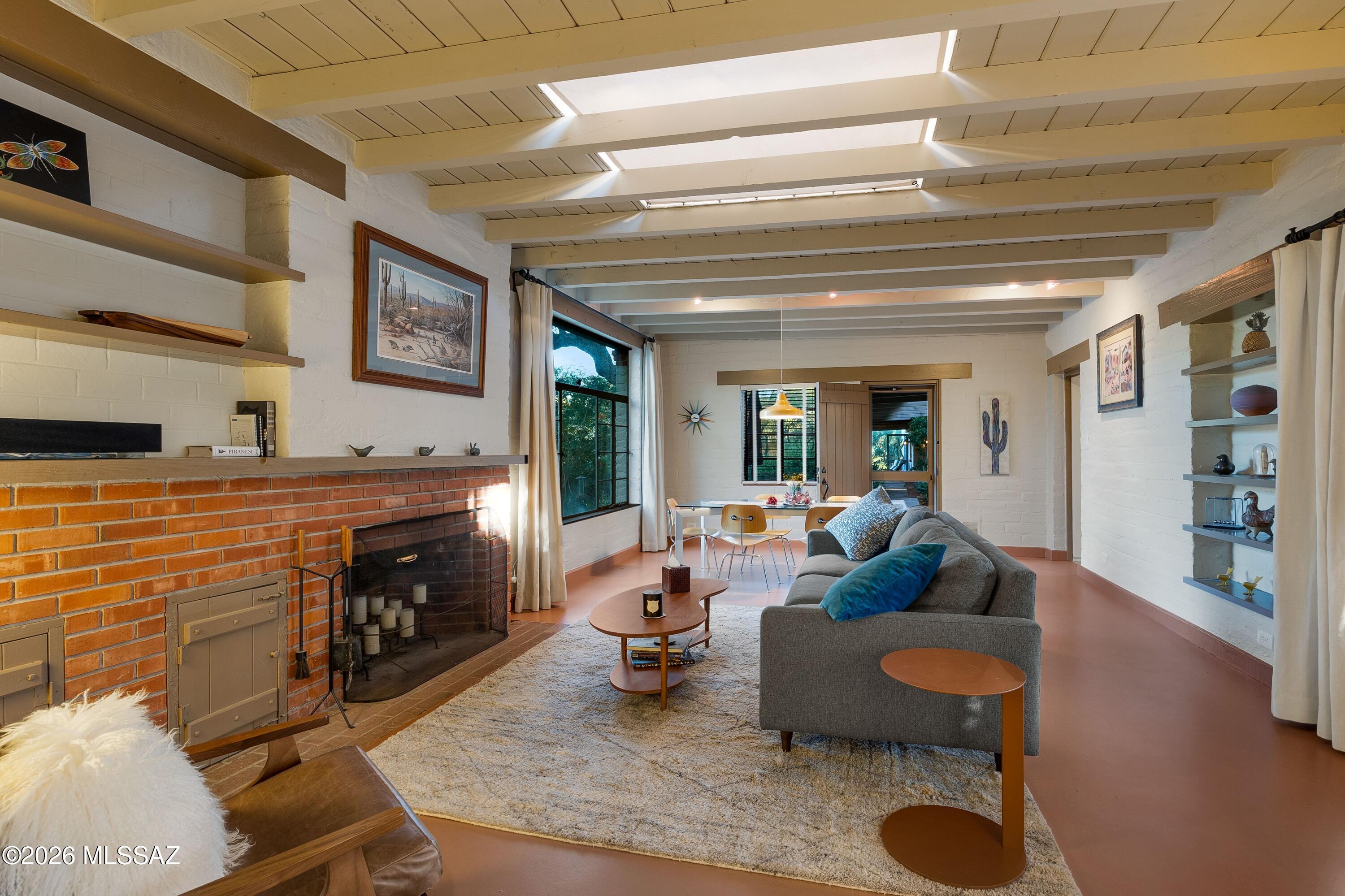 A distinctive 2.1-acre Joesler estate offering privacy, architectural character, and exceptional outdoor living in the heart of Casas Adobes. Originally constructed in 1948, this mud adobe residence showcases the craftsmanship associated with renowned Tucson architect Josias Joesler and includes a separate 1,022-square-foot casita, providing exceptional flexibility for guests, a private office, creative studio, or rental use. 

Extensive improvements have been completed throughout 2026. The pool and tile were completely renovated in July 2026, the driveway was fully resurfaced, and the entire exterior was freshly painted, including the courtyard walls. The HVAC system is only a few years old, the roof was recently recoated, both leach fields were replaced less than 10 years ago, and the grounds have been freshly landscaped.

Set amid mature landscaping with mountain views, the property offers a private retreat while remaining conveniently located near the Casas Adobes Shopping Center, Whole Foods, restaurants, fitness facilities, and other amenities. Inside, custom architectural details, abundant natural light, and thoughtfully positioned windows connect the home to its surrounding landscape. The primary suite features a spacious walk-in closet and beautifully detailed bathroom with artistic glass and tilework, while the kitchen features a large pantry room.

Outdoor living is a defining feature, with multiple covered patios and inviting entertaining areas throughout the property. A built-in outdoor grill and tortilla oven create an ideal setting for gatherings, while the renovated pool provides a beautiful centerpiece for enjoying the Tucson climate. An RV carport adds valuable utility and convenience.

With its architectural pedigree, expansive grounds, guest house, extensive outdoor amenities, and versatile potential for residential, professional, creative, or rental use, this property offers a rare opportunity to own a truly distinctive piece of Tucson.