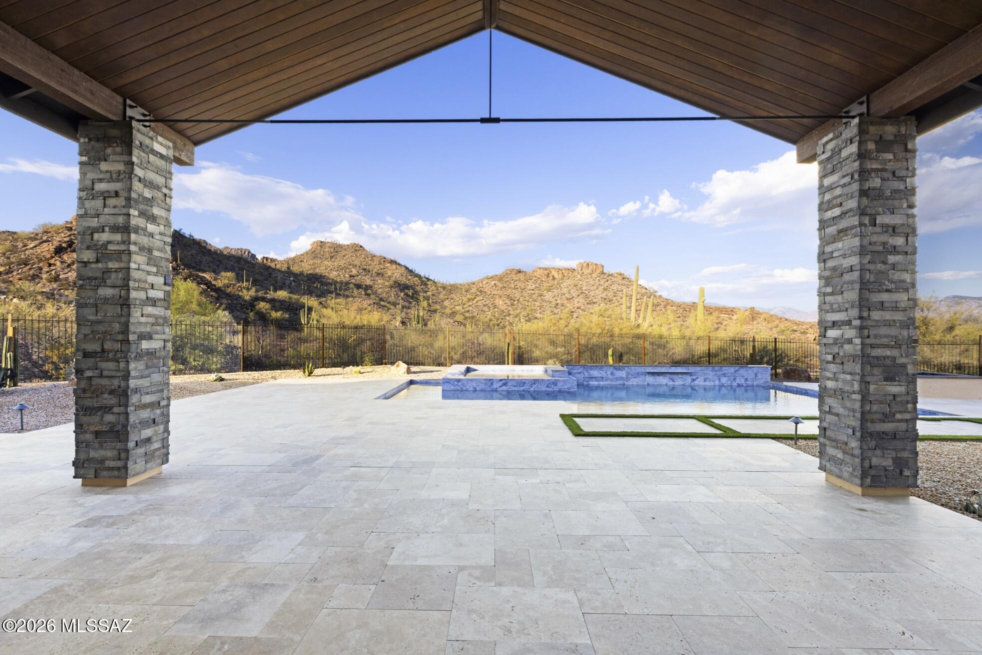 This beautiful Custom Modern style home is in the gated community of Canyon Pass in Dove Mountain. The architect designed this home to capture the crested hills at the base of the Tortolitas, Catalinas and the cascading Tucson Mountain views with specifically placed series of corner window. A separate casita and all en-suite bedrooms, open floor plan blended with high lofty ceilings, 5 x 10 entry pivot door, large fireplace, expansive sliding glass doors open to the private covered patio, pool and spa.  The spacious chef kitchen offers a large island, Wolf appliances, Subzero refrigerator, and custom cabinets. Large format tile compliments this symmetrically sophisticated modern home. Agent is related to Seller/Principal who is a licensed Realtor in the state of Arizona.