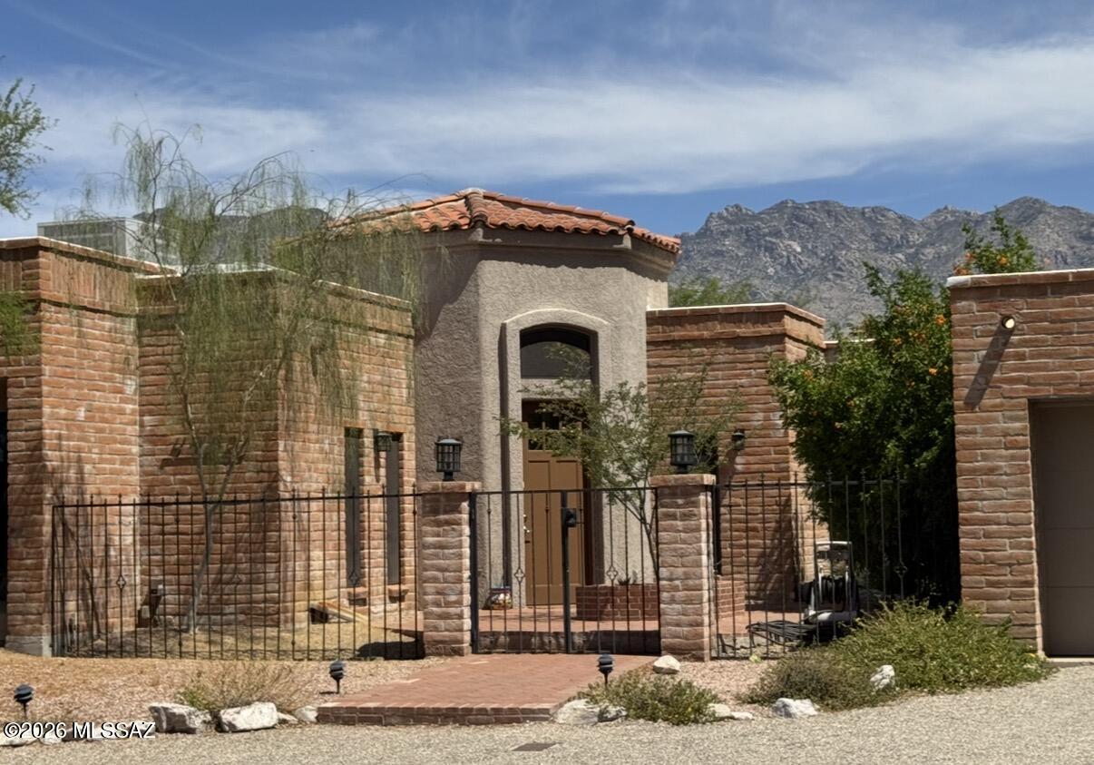VIEWS VIEWS!  Stunning views of both the Catalina mountains, downtown & valley lights at night, this 2,882 sq ft 3 bedroom spectacular home is in the center of the Foothills of the Catalina Mountains.  The large circular drive has plenty of room for guest parking. Note the enclosed courtyard that begs for a fountain, or ?, leading into a 14x14 large welcoming foyer with 12' high ceilings. Note the Travertine tile throughout, & paid for solar! The 30x30 spacious living room has city & mountain views, & stunning ceiling adornment adding additional drama; the family room has great Catalina Mountain views & a fireplace.  The kitchen offers a valley view to the west, & oodles of cabinet space. Note the formal dining room. The spacious back yard has room for a heated pool & spa. Come See It!