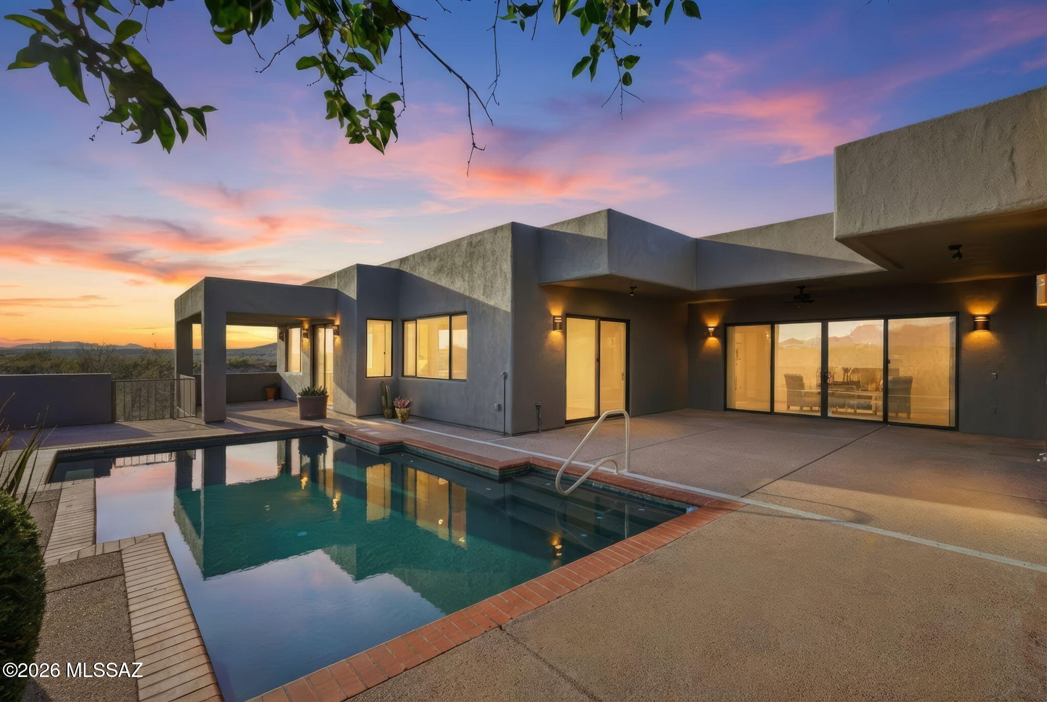 This is where luxury meets creativity, where every space was designed to be experienced—not just seen—and where the desert itself becomes part of the home's story. Before the mountains take your breath away, this home steals your attention. Hidden at the very end of a cul-de-sac in the gated sanctuary of Madera Shadows. As you approach, fresh exterior paint glows against the natural landscape while a softly trickling water feature sets a calming rhythm. Step inside to discover colored concrete floors that flow seamlessly throughout, perfectly complemented by fresh interior paint & abundant natural light. At the heart of the home, the chef's kitchen is both functional and artful, featuring a gas cooktop, tile countertops, custom hickory cabinetry, pot filler, and a generous walk-in pant Adjacent to the kitchen, a built-in buffet provides exceptional storage and effortless flow for entertaining. The great room is a show stopper with floor-to-ceiling views that frame the shimmering poolrecently serviced to remove calcium buildupand the dramatic Santa Rita mountain backdrop beyond. Anchoring the space is a gas beehive fireplace, paired with a custom TV console that mirrors the built-in buffet cabinetry for a cohesive, high-end finish. Center stage, a custom round dining table and chairsincluded with the saleinvite unforgettable gatherings beneath a one-of-a-kind art chandelier, a true statement piece valued at over $20,000, which conveys with the home. The primary suite is a private retreat designed for daily indulgence, offering dual vessel sinks, a soaking tub wrapped in tile, and a tiled walk-in shower. As you prepare for the day, an interior atrium window provides a gallery-like settingperfect for showcasing favorite artwork in natural light. Thoughtfully designed separate guest living quarters feature their own entrance to a private patio and the heated pool (with a new pool heater), and are independently climate-controlled with a mini-split systemideal for extended guests or multigenerational living. Outdoor living truly shines here. The extended covered patio is an entertainer's dream with a built-in BBQ, lounging areas, and even an outdoor tiled showerperfect after a swim under the desert sun. For creatives and hobbyists, the property offers an expansive workshop/studiofreshly painted and equipped with two industrial-sized kilns, served by two new evaporative coolers. Whether you're an artist, woodworker, or gearhead, this space opens endless possibilities. While the home includes a two-car garage, portions of the studio could be converted to additional garage space if desired. Additional highlights include:

Recently recoated roof

Refreshed desert landscaping

Solar panels for low monthly utility costs (leased; buyer to assume)

Termite warranty through Bill's Home Service

Kilns can be removed upon request

Set on 2.85 acres, this property offers rare peace, privacy, and room to breatheyet remains conveniently located. The home is not age restricted, and buyers may opt into GVR membership, unlocking access to fitness centers, clubs, classes, pickleball, arts, theater, and more.

This is more than a homeit's a lifestyle, a canvas, and a sanctuary. A place where luxury feels personal, views feel endless, and every detail tells a story.
