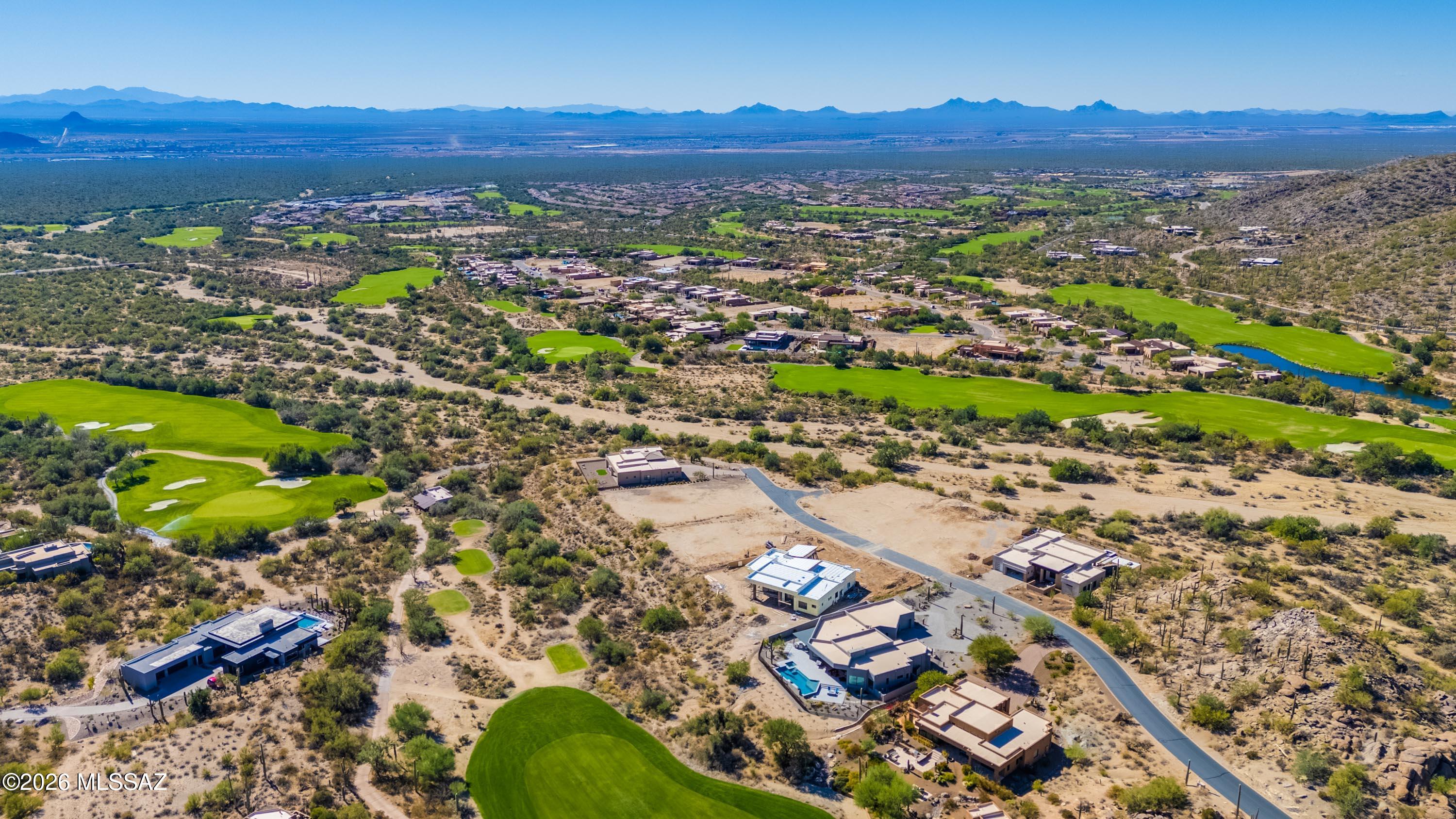 A rare end-lot position in The Overlook, the double-gated custom-home enclave at the heart of Dove Mountain. This graded homesite sits at the edge of the community and backs to protected natural common area, delivering corner-lot privacy, added open space, and sweeping mountain and desert views. Major site work is complete, so you skip the site-prep timeline and design right away. Build your own plan, or start from our custom desert-contemporary plans with options like guest houses, pool, spa, and more. Minutes from the Ritz-Carlton, The Gallery Golf Club, and Gallery Sports Club, with 50+ miles of trails.