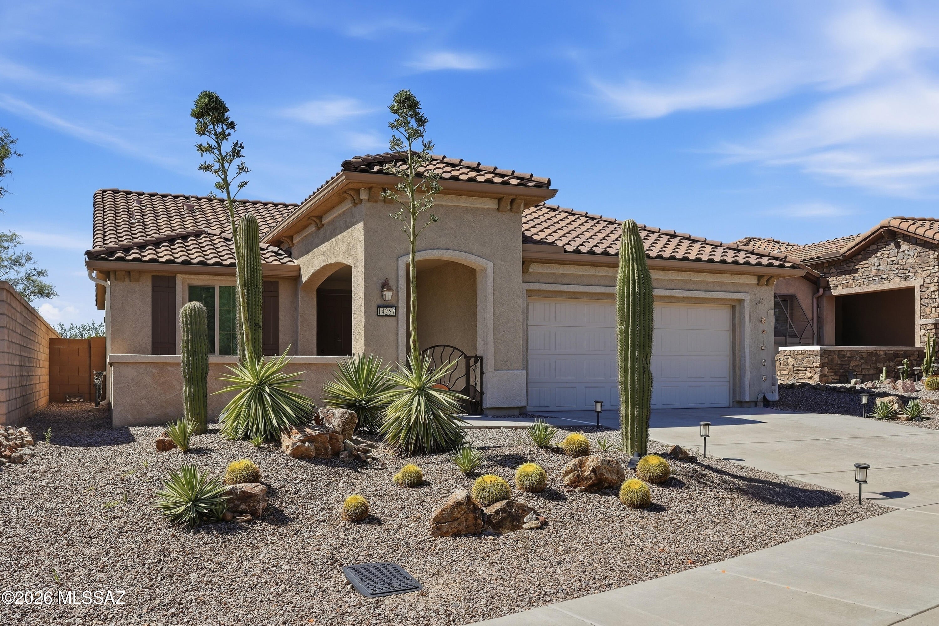 Beautifully upgraded home in Del Webb Dove Mountain, an age-restricted community. Features 2 primary suites plus den, 2.5 baths, & a 4-ft extended garage. Premium corner lot with upgraded elevation & low-maintenance landscaping w/ drip system. Beautiful upgrades inside including block out blinds throughout to reduce AC bills  Stunning kitchen w/ upgraded cabinets, granite counters, large walk-in pantry, stainless appliances & breakfast bar. Great room w/ double slider for easy indoor-outdoor living. Covered patio w/ epoxy floors, ceiling fan, & roll-down sun shades. Laundry room remodeled w/ LG stacked tower, butcher-block counters, & Kohler faucet. Garage includes insulation, epoxy floors, & shelving. Located across from the park where many gather w/ their dogs, Saguaro Center is near by & easy access into & out of Del Webb