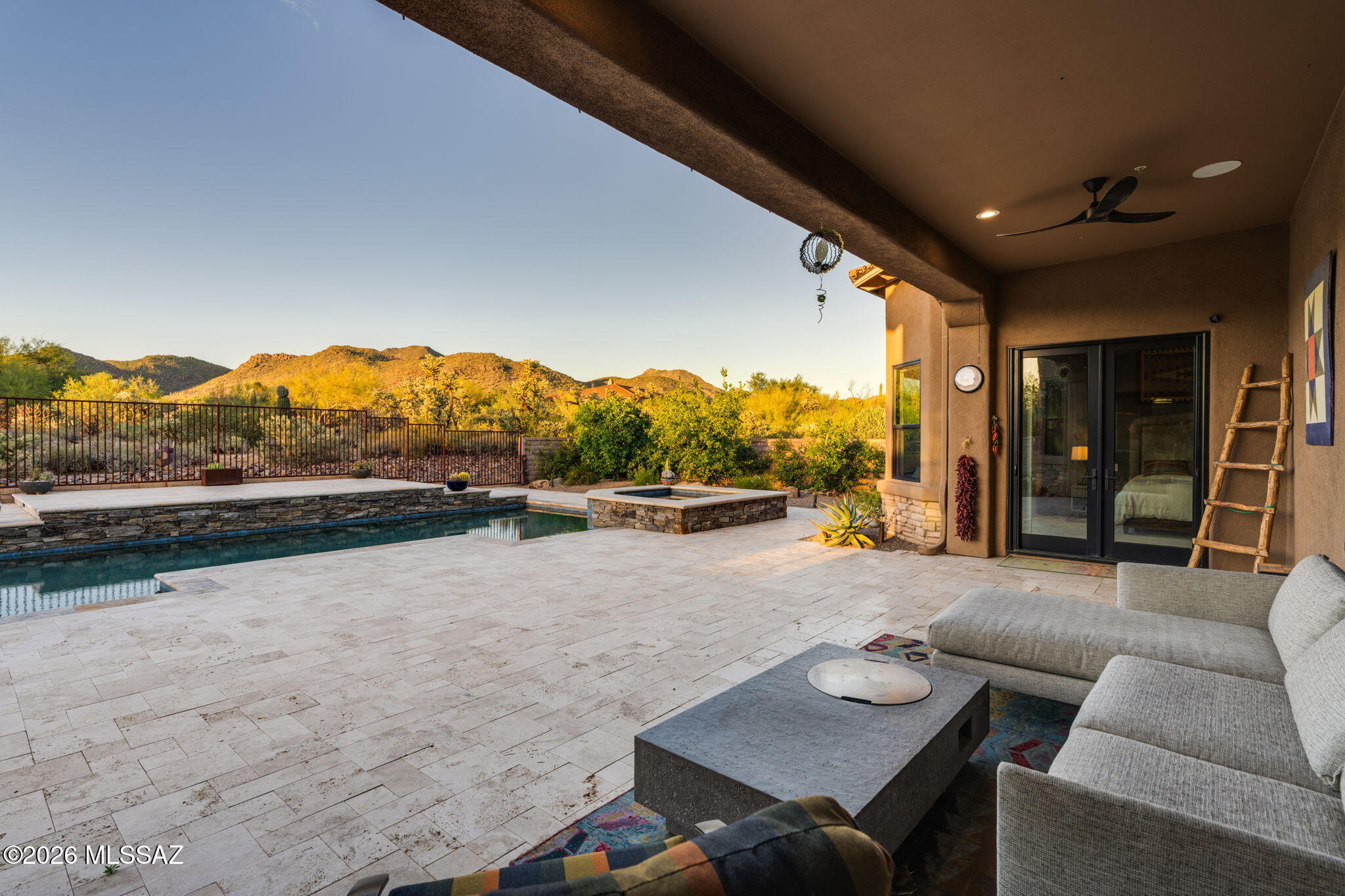 Sweeping UNOBSTRUCTED MOUNTAIN VIEWS.  Reimagined GATED Dos Lagos home with $500,000+ in upgrades into a 2026 showpiece!  Moments from The Gallery & The Ritz-Carlton - nearly ONE ACRE. Open, split-bedroom design, travertine floors, Alder doors. Fully remodeled kitchen: two-tier quartz/ mesquite counters, custom cabinetry, BLUE STAR appliances, entertainer's bar. Primary suite with dual floating vanities, soaking tub, oversized walk-in shower; secondary bedrooms have private baths. Backyard resort: SALTWATER pool w/ new heater/pump, enlarged spa, outdoor kitchen, putting green, travertine pavers, lush landscaping, north-facing patio. Oversized extended 3-car garage. Private, palatial, precisely upgraded. Recent: 2 new variable 20-seer HVACs, tile roof, rear windows, & 2 lots ADDITIONAL UPGRADES & INFORMATION:
6096 W Sonoran Links Lane, Marana, AZ 85658 

Set behind the gates of Dos Lagos at Dove Mountain, just moments from The Gallery Golf Club and The Ritz-Carlton, this exceptional residence delivers the privacy, finish level, and resort lifestyle sought by the most discerning buyer. Positioned on just shy of an acre with commanding Tortolita Mountain views, the home has been extensively redesigned with more than $500,000 In thoughtful upgrades. 

The open, split-bedroom design balances impressive entertaining spaces with everyday comfort. Travertine flooring, rich Alder wood doors, custom accent walls, and integrated indoor/outdoor sound create a polished, cohesive feel throughout. A formal living room anchored by a stacked-stone fireplace and an expansive family room provide beautiful settings for both intimate evenings and larger gatherings. 

The newly remodeled kitchen is a showpiece. Dramatic two-tier quartz counters, accented by mesquite wood, paired with extensive custom cabinetry, breakfast bar, and BlueStar appliances. A custom-designed entertainer's bar offers generous storage for wine, glassware, and serving pieces--an elegant and functional space made for hosting. 

The private primary suite is tucked away from the guest wing and feels like a true retreat. Custom walk-in closets, floating dual vanities, a freestanding soaking tub, and a spacious walk-in shower finished in custom tile to create a spa-like setting. Each secondary bedroom includes its own en-suite bath, providing comfort and privacy for family and guests. 

Outside, the home opens to a fully transformed backyard designed for year-round Arizona living. The saltwater pool features a new heater and pump, while the enlarged spa is finished with beautiful, stacked stone. An outdoor kitchen with a Napoleon grill, travertine pavers, a putting green, custom ironwork, lush, updated landscaping, fruit trees, and carefully placed lighting create an exceptional private setting. The north-facing covered patio frames the mountain views, open desert sky, and memorable sunset evenings. 

Significant improvements include two 20 seer variable speed 5 ton HVAC systems, a new tile roof, new back windows, insulated garage doors, added gutters, fresh interior and exterior paint, new irrigation with timer, and upgraded exterior lighting. The oversized three-car garage includes built-in storage and accommodates larger vehicles with ease. 

This is a rare opportunity to own a completely refreshed, move-in-ready home in one of Dove Mountain's most desirable gated communities - --close to world-class golf, resort amenities, and the natural beauty that makes this part of Southern Arizona so special.