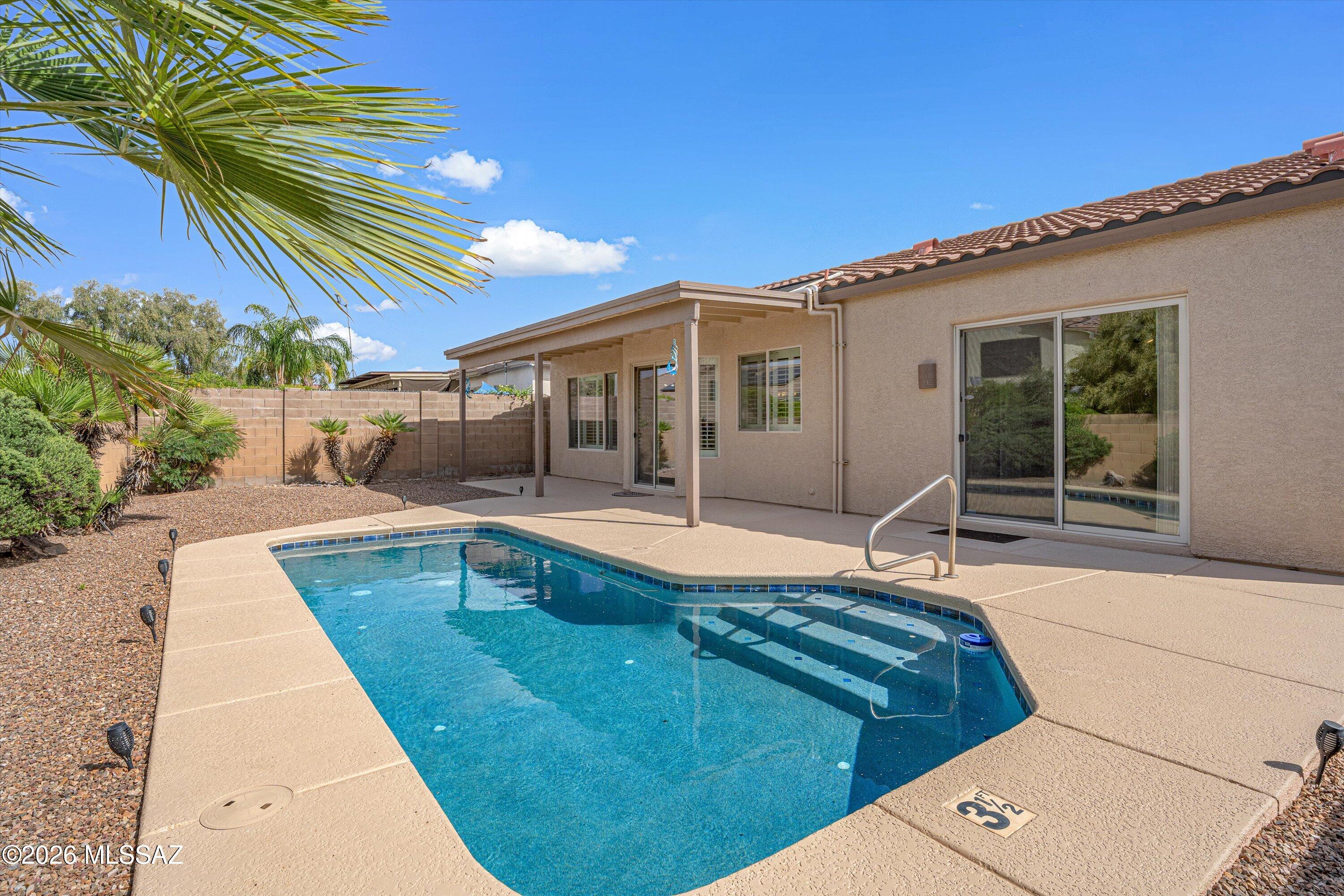 Move-in ready Pulte home in desirable Continental Ranch, built in 2002, offering 3 bedrooms, 2 baths & a spacious 3-car garage. Enjoy an updated kitchen w/Cambria quartz counters, stainless steel appliances, gas range, refrigerator included, large pantry, pull-out cabinetry & a center island overlooking the family room. The open layout includes living & dining areas, complemented by plantation shutters throughout. Step outside to a private backyard with covered patio, sparkling pool & beautiful mountain views. The primary suite features a sliding door with direct access to the pool. Primary bath has double vanity, soaking tub & separate shower accented w/tasteful tile. Additional highlights include a charming front courtyard & low-care front & back yards--perfect for easy Arizona living.