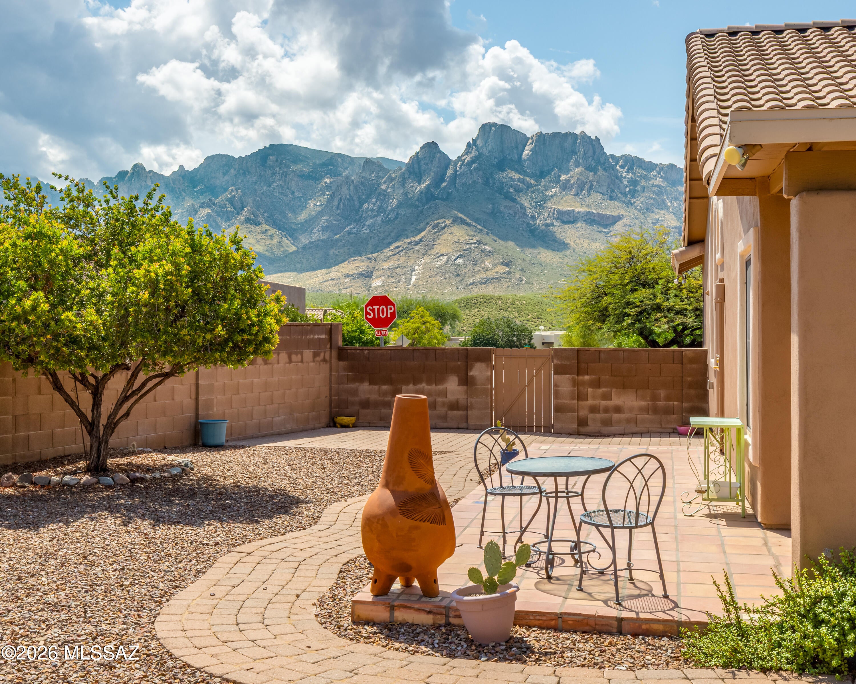 Beautifully updated single-story 4BR/2BA 1,863sf home in Catalina Shadows, ideally situated on a premium corner lot offering exceptional privacy and Catalina Mountain views. Home has tile flooring throughout except secondary bedrooms, plantation shutters, sun screens and an updated primary bath with an upgraded shower and vanity. Major improvements total almost $50,000 including replumbed water lines, no polybutylene piping, along with a newer heating and air-conditioning system, whole-house GFCI upgrades, water purification system & updated landscaping rocks, plants, tree & irrigation lines. The inviting living space features a fireplace, while the flexible fourth bedroom works equally well as a den or home office. Backyard features a newer covered patio roof, surrounded by updated low-care landscaping with wonderful privacy, mature plantings, fruit trees and your own putting green, all enhanced by beautiful mountain views. The block wall has also been extended for additional privacy. Located in desirable Catalina Shadows in the heart of Oro Valley, this home offers a wonderful combination of privacy, mountain views and convenience. Enjoy easy access to Oro Valley Marketplace, shopping, restaurants, medical facilities, golf, parks and recreation, along with nearby hiking and biking opportunities. And all everyday conveniences are close at hand. With its established neighborhood setting and proximity to so many of Oro Valley's amenities, this is an ideal place to enjoy the best of the Arizona lifestyle.