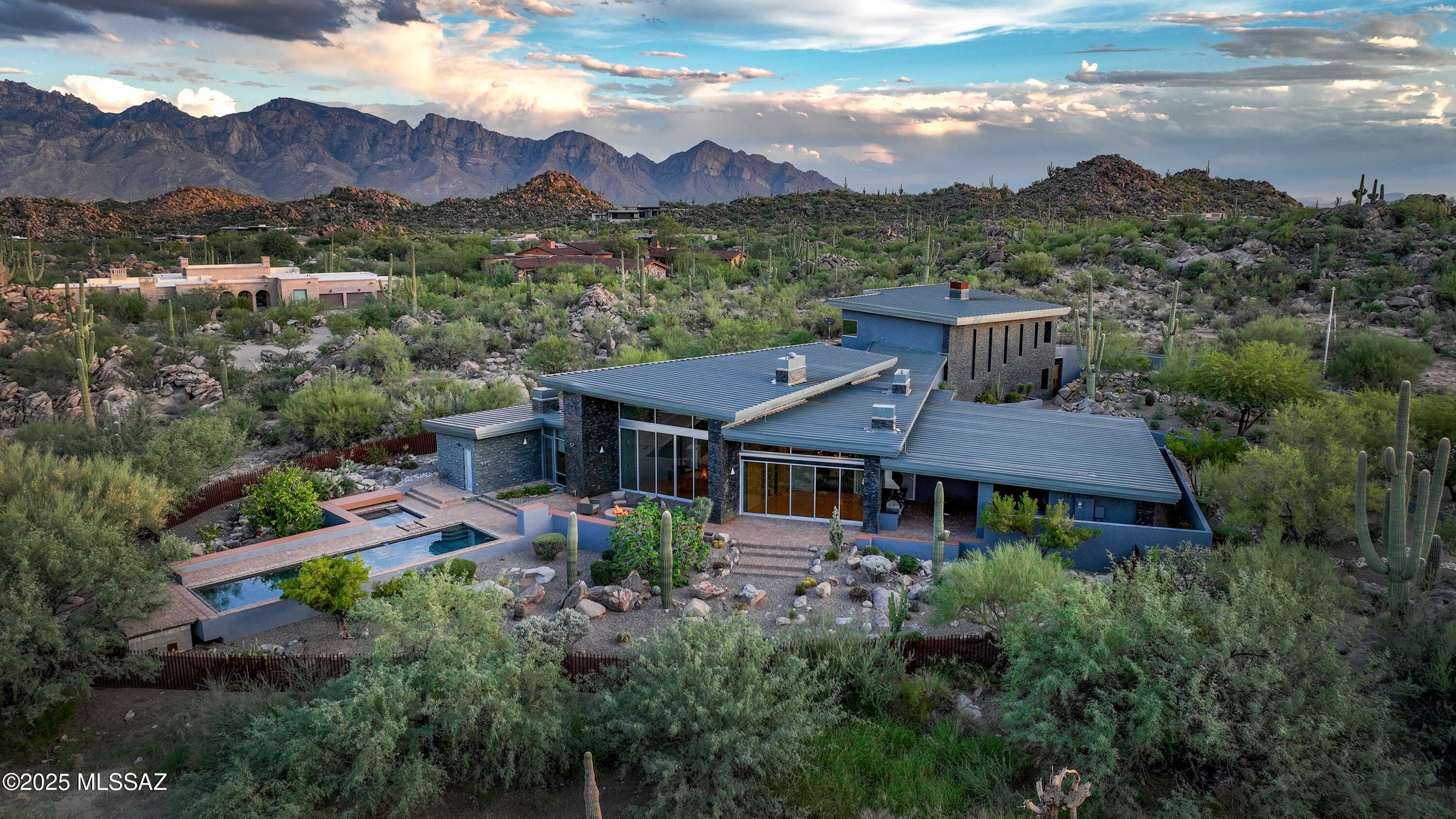 An exceptional offering in the prestigious Stone Canyon golf community, this modern contemporary estate is situated on a private, three-acre parcel with breathtaking desert and mountain views. The home, which includes a 4,000 sq ft main residence and an attached 2,000+ sq ft versatile addition, offers a total of over 6,000 square feet of meticulously designed living space. The flexible addition can serve as luxurious guest quarters, an art studio, a second great room, or many other possibilities. Located in a premier gated community consistently ranked among the top residential golf communities in the country, this property provides an unparalleled value proposition for a discerning buyer seeking a sophisticated desert lifestyle.