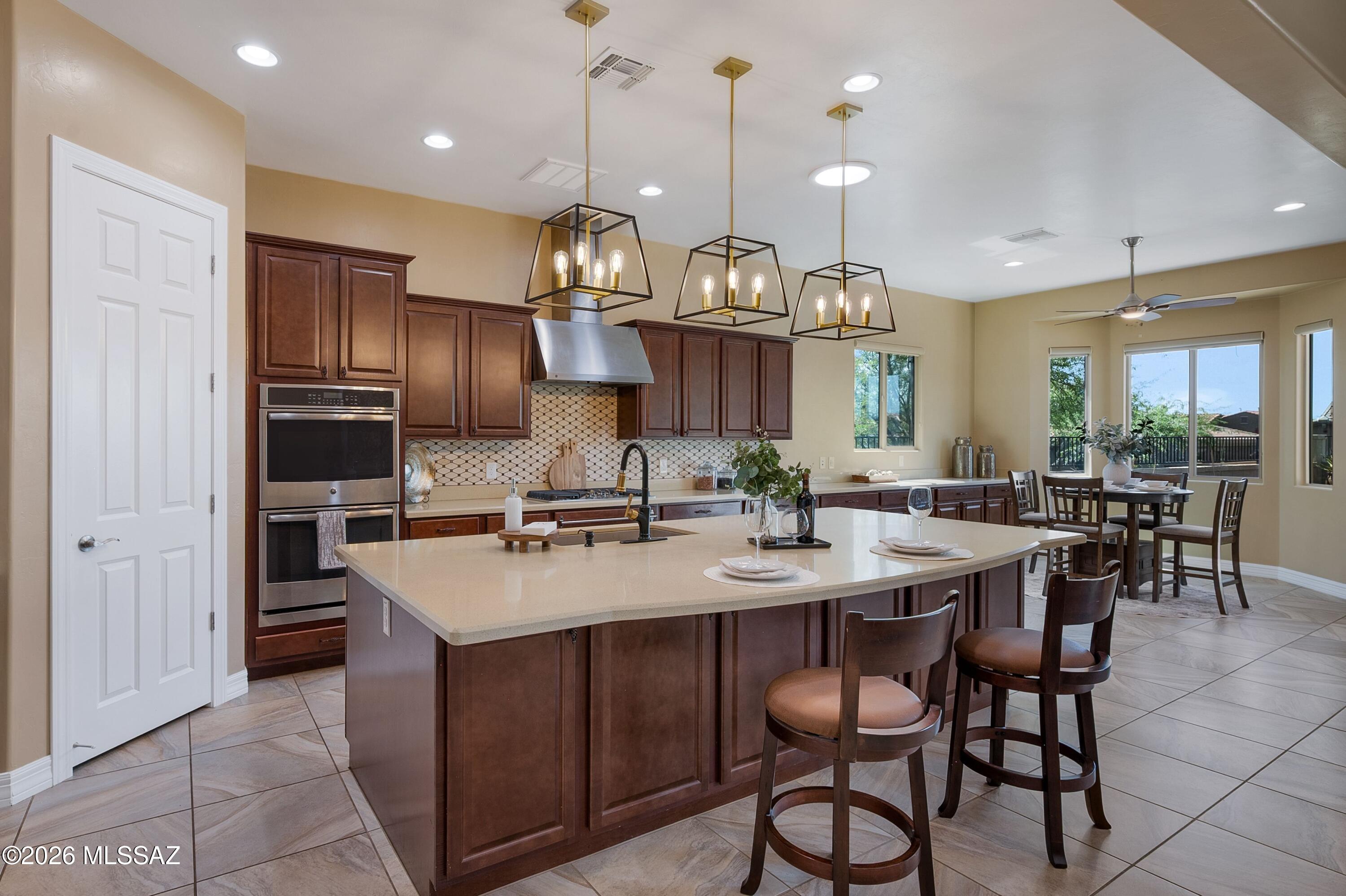 Elevated Desert Living Awaits in the Gated Summit North Community at Center Pointe in Oro Valley! Tucked on a Quiet Cul-de-Sac, This Stunning 3BR/3.5BA Home Features Mountain Views & an Open, Light-Filled Design Enhanced by Soaring 12-Ft Tray Ceilings. The Gourmet Kitchen Features Quartz Countertops, Stainless Steel Appliances, Double Ovens & Gas Range. The Spacious Primary Suite Offers a Serene Retreat, While a Second En-Suite w/ Walk-In Closet Is Ideal for Guests or Multi-Generational Living. Enjoy a Tandem Garage w/ Built-In Cabinets, Water Softener & Laundry Utility Sink. The Backyard Is Made for Arizona Living w/ Travertine, Turf, Covered Patio & Extendable Awning, Gas Line & Premium Bullfrog Spa. Community Amenities Include a Clubhouse, Pool, Splash Pad, Parks & Scenic Trails.
