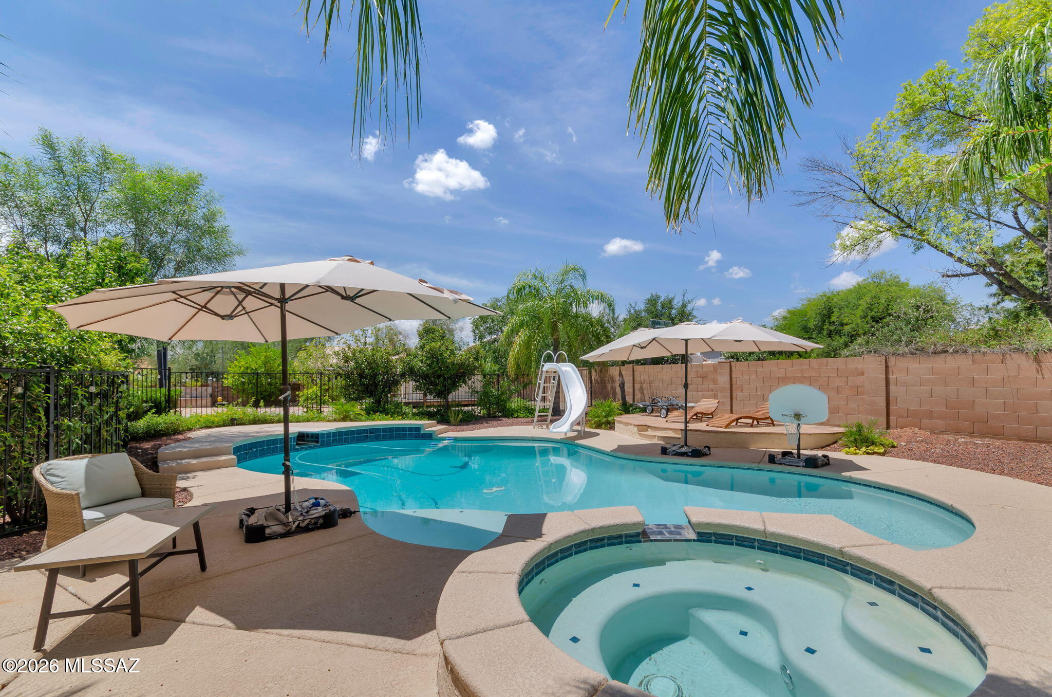 Welcome to Oro Valley/Rancho Vistoso living as it was designed to be enjoyed. This home has been lovingly modernized & functionally improved to include complete kitchen open concept remodel, new cabinets, quartz counters, 72'' built-in Sub-Zero Refrig & Freezer, 48'' commercial grade Viking Range, new sink, garbage disposal & fixtures. New flooring & bathroom updates. Fresh Interior Paint Throughout. The resort styled backyard with solar heated spa, sparkling pool, slide/diving board makes for recreational living. The 1/3-acre manicured lot offers built-in BBQ, expansive patio, misters, citrus & ash shade trees, firepit, walkway lighting, kids' playhouse or storage shed. 5 Beds, 3 Baths, Office & Upstairs Media/Game Rm. EV Charger in large garage.