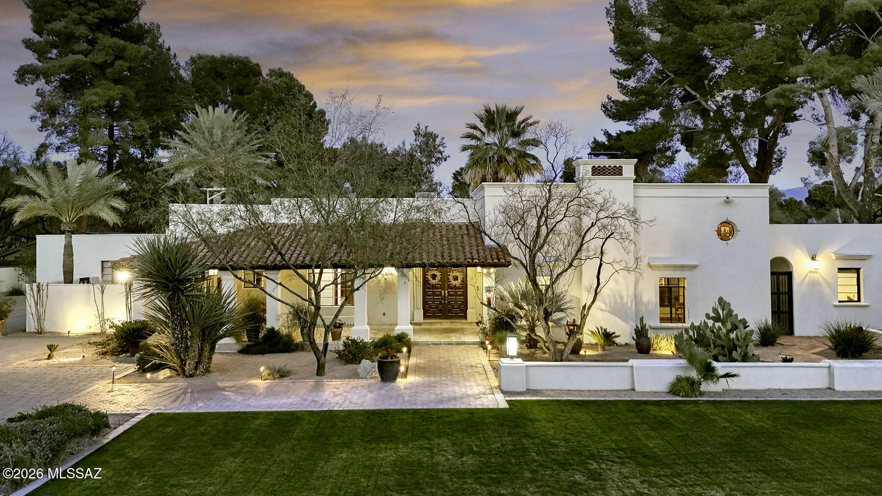 Magnificent & Classic Santa Barbara style home situated on the finest 1 Acre Golf Course homesite in the prestigious guard gated Tucson Country Club. A lovely natural stone driveway, expansive grass area & covered veranda invites you into this exceptional home with over 4669 sq. ft. in the main house. A dramatic gallery entry with high beam ceilings & French doors creates an ambiance of warmth and grandeur.  Exquisite living room with high beam ceilings, dramatic fireplace, a loft library, natural stone floors & French doors that lead  to a charming lushly landscaped courtyard with a Romeo & Juliet balcony. Formal dining room, gourmet island kitchen with granite countertops, stainless steel appliances, Wolf 6 burner gas range, Wolf microwave, double ovens..... continued ...... .... Sub Zero refrigerator/freezer, Asko dishwasher, Sub Zero wine cooler, breakfast bar, pantry, family room with fireplace, beautiful wood plank floors, 4 bedrooms & 5 baths in the main house including primary suite with antique wood double entry doors, sitting area, wood plank floors, spacious walk in closet, luxurious bath with double vanities, quartz countertops, garden tub, sensational shower & private entry to the rear patio, laundry room with storage & a 3 car garage. The separate guest house with 574 sq. ft. features a wonderful living area, bath, kitchenette with countertop, sink, small fridge, covered patio & an oversized tandem garage. Enjoy resort like gracious outdoor living with extensive covered patio, gorgeous pool, grass, lush landscaping, upstairs viewing deck, walk or drive your golf cart to the Country Club & fabulous mountain & golf course views. This home has it all!!!