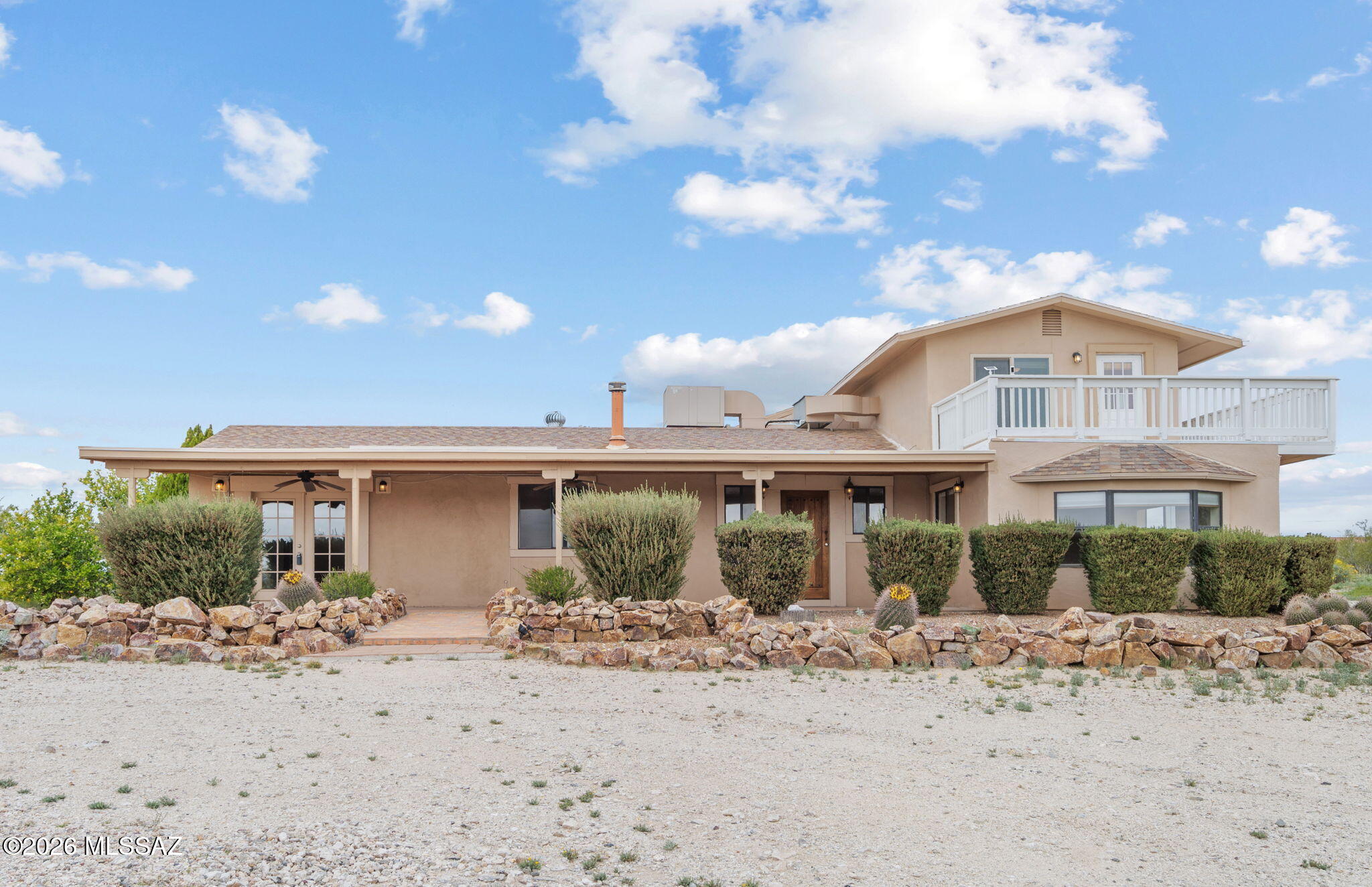 Perched on an elevated 4.97-acre lot with sweeping mountain views, this 2,340 sq ft, 3-bedroom, 2-bath property offers space, privacy, and endless potential. The home features a functional layout ready for a new owner to personalize, update, and truly make their own. Ideal for those seeking room to spread out, the property includes a private well, expansive 5-car garage, and a dedicated workshop--perfect for hobbyists, car enthusiasts, or extra storage. With horse privileges and wide-open land, this is a rare opportunity to create your own desert retreat while enjoying the peace and beauty of Southern Arizona. Whether you envision a modern renovation or a custom ranch escape, this property provides the foundation to bring your vision to life.