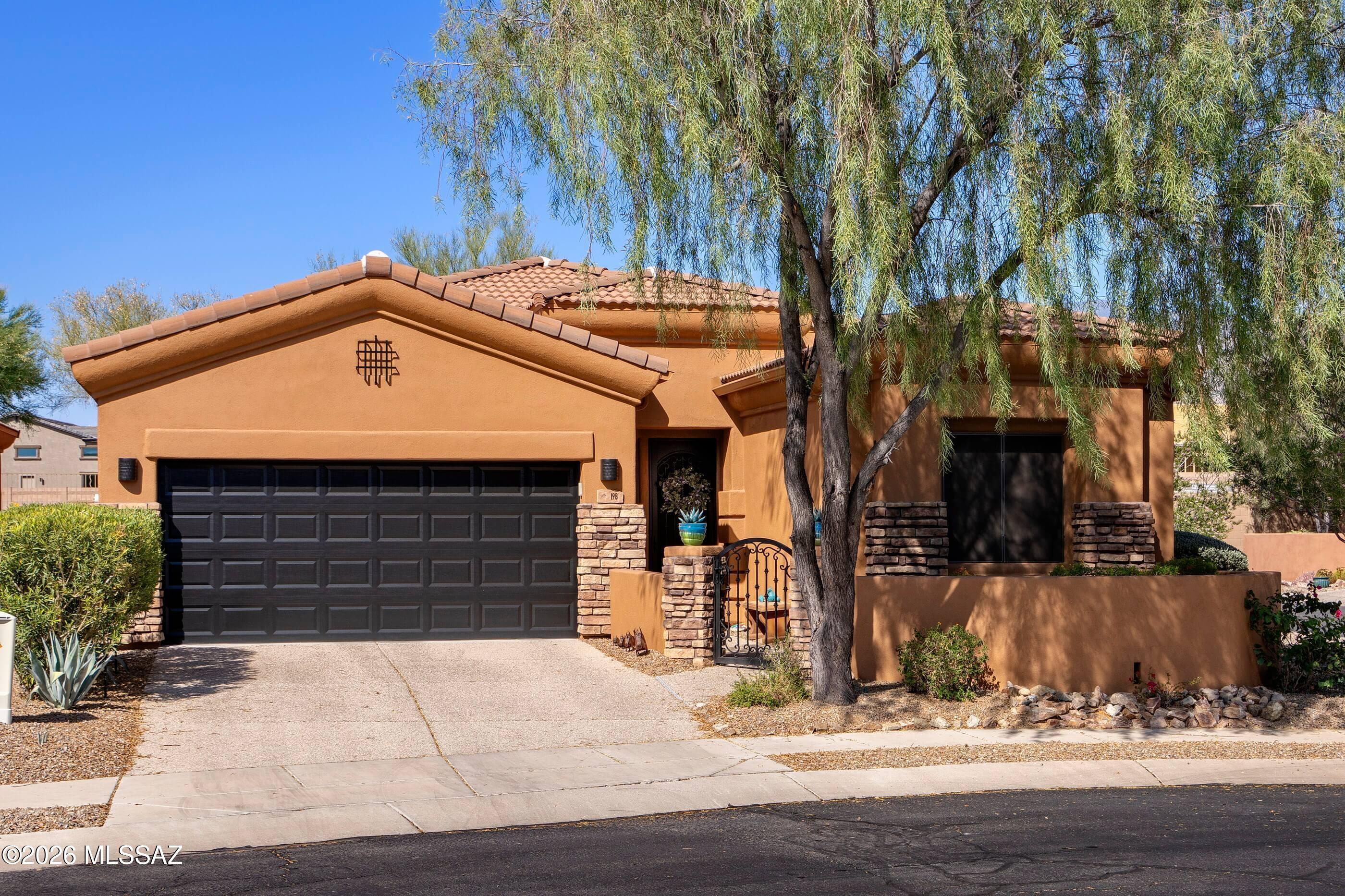 TURN KEY--everything included! This beautiful home would be ideal for snowbirds or investors expanding their vacation rental portfolio. Loaded with high-quality furnishings, art and housewares, this three bedroom, two bath, 1955 square foot home is in the heart of Oro Valley and mere moments from shopping, dining, Catalina State Park, the Loop and more!A tidy front courtyard with stone façade work and an iron gate complement the matching security front door. Colorful and welcoming, this home offers an open living plan with split bedrooms. There is easy care tile throughout the living areas, kitchen, bathrooms, laundry and one guest bedroom, while another guest bedroom and the primary both have soft carpet. Additional upgrades include custom blinds and sunshades. The living space invites the outdoors in with large windows and a sliding glass door to the fully walled backyard. Chilly winter evenings become cozy with the flip of a switch on the gas fireplace, and the large reclining sectional sofa makes game day or movie night a treat.    An adjacent dining area with clerestory windows has plenty of room for a larger dining set, if desired. The kitchen features a GE Profile stainless-steel appliance package including double ovens and a gas range, plenty of cherry cabinets with pullouts and under cabinet lighting, a pantry and granite counters. The breakfast bar is accented with pendant lighting and includes seating for four. A nearby laundry room has a GE Profile front-loading washer and dryer set, storage cabinetry and a folding counter. The cabinets are full of everything you need-- Calphalon and Rachel Ray cookware, Fiesta ware, Mikasa glasses, Pfalzgraf flatware and more. The primary suite is separated from the two guest bedrooms, affording privacy and access to the patio via a sliding glass door.  This room has an Ashley king bedroom set with Sealy Posturepedic mattress, a Lazy Boy oversize recliner, an entertainment center with an electric fireplace and 75" TV. The ensuite bathroom has dual sinks, a walk-in shower, grooming station with extra lighting and separate toilet room with a pocket door. There is a large walk-in closet with to-the-ceiling storage space. Two guest bedrooms occupy the other side of the home and share a full hall bath. Both guest bedrooms have additional storage cabinetry built above the closets. One offers a sofa bed, sitting chair, and a writing desk with swivel chair; the other bedroom features a five-piece executive office set from Ashley furniture. Both could easily be full-time bedrooms by swapping the furniture. The two-car garage has a convenient utility sink and ceiling wire rack storage. The private backyard has been walled in for privacy and offers Catalina Mountains, delightful water feature and a large paver patio. Summer afternoons are shady back here due to the orientation and the mature plantings, and the covered portion of the patio also has a ceiling fan for added comfort. You can enjoy from the very first day--along with the metal yard art sculptures, the patio furniture, grill and firepit are also included. In addition to the carefully selected furniture, this home is completely outfitted with everything needed to enjoy seasonally or year-round--from housewares to linens, electronics to two Trek bicycles. The new owner just needs to bring their clothing and personal items!  A complete list of items can be found in the documents section of the MLS listing. Don't wait until fall, this home will be sold before then!