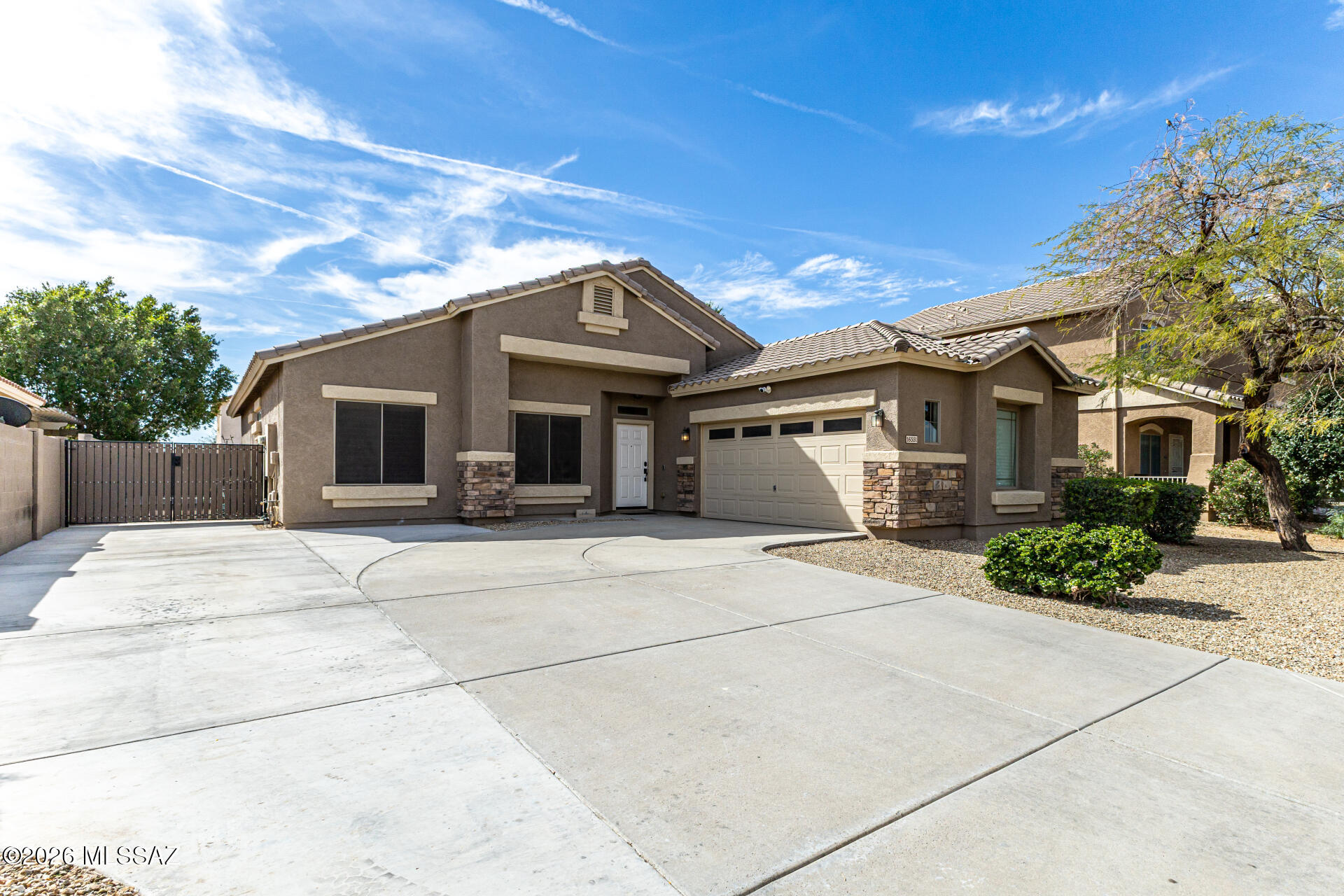 TONS OF UPGRADES; Rare opportunity to own a truly unique home in Canyon Trails featuring a private basketball court and fully finished entertainment backyard designed for active Arizona living. This beautifully modernized 4-bedroom home combines comfort and functionality with upgraded interiors, a spacious open layout, and thoughtful enhancements throughout. The standout backyard offers turf, extended hardscape, and space ideal for recreation, gatherings, or relaxing evenings at home. Additional highlights include a THIRD driveway, RV gate, plantation shutters, and a private primary suite complete with its own fireplace. Move-in ready and unlike typical neighborhood homes, this property delivers a lifestyle experience that sets it apart from the rest.. Also, the loan is assumable at 3.49%.
