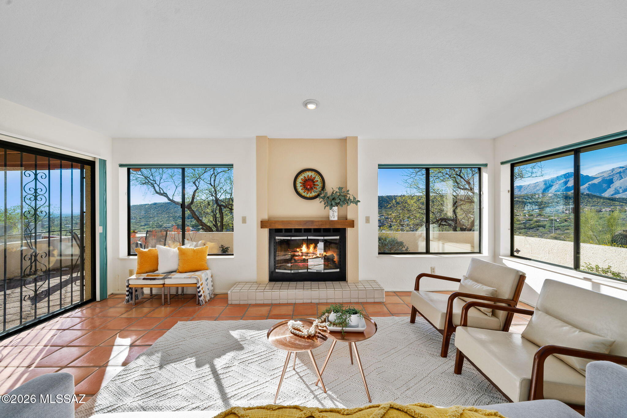Come for the convenient location, stay for the views! This well-maintained home is filled with natural light, warm Saltillo tile flooring, vaulted ceilings, and picture windows that frame scenic desert and mountain vistas. The inviting living room features a wood-burning fireplace and serves as the heart of the home, ideal for relaxing or entertaining. The kitchen offers custom maple cabinetry, granite countertops, a large center island for meal prep, a breakfast nook, and a spacious dining area for gatherings. The main floor includes a primary bedroom with en-suite bath featuring updated cabinetry, plus an additional bedroom with an adjacent full bath. Upstairs, you'll find two additional bedrooms & full bath, providing flexible living space. Extend your living space outdoors to the patio Low care desert landscaping means low maintenance so you can just sit back, relax and enjoy the mountain, city and sunset views along with the occasional deer passing through. The lot extends over the hillside. Perhaps a place to do an extended deck to expand the yard space? Additional highlights include a two-car garage, solar-assisted water heater, one HVAC unit replaced in 2025 (second floor unit). Conveniently located near Sabino Canyon recreation center, shopping, dining, bike paths and golf. Whole Foods Market is 3.1 miles to the west. Contact your favorite Realtor for a personal tour today! This home is a must see.