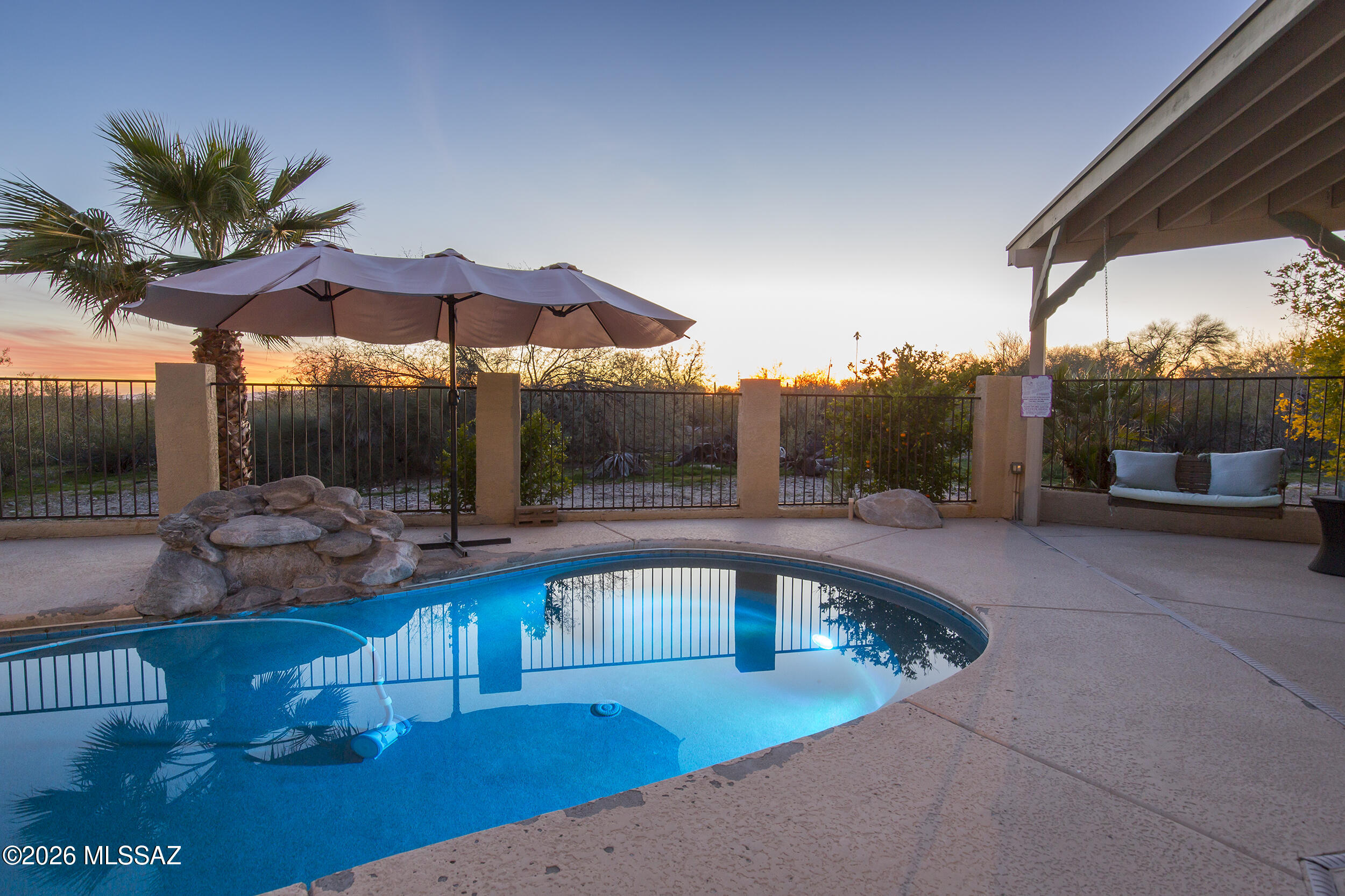 Located in Flecha Caida near Alvernon and River Road, this Catalina Foothills home features owned solar installed in January 2023 with a 30-year warranty, resulting in little to no electric bills. The flexible split-floor plan offers 4 bedrooms, 3 baths, a large family room, office, and ideal multi-generational living. The oversized garage accommodates 4-5 vehicles, including a massive workshop/storage/recreation space with a dog run behind it. Additional features include new gutters, water-harvesting cisterns, passive pool heating, and drip irrigation. Enjoy outdoor living with a fireplace, built-in kitchen area, sink, and extensive high-end granite throughout the kitchens and baths. See the floor plan to appreciate the garage's impressive size. Owner is a licensed AZ real estate agent.