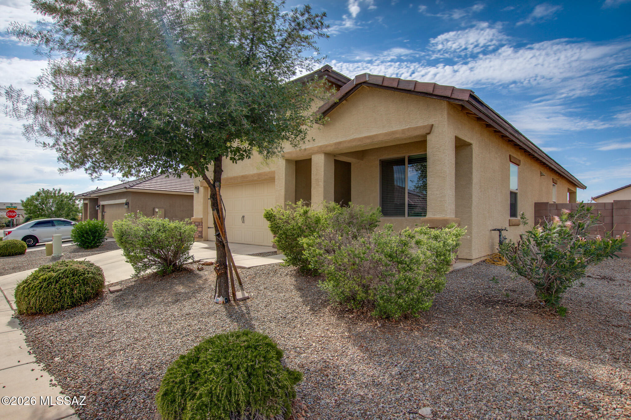 Beautiful & Move-In Ready in San Lucas! This exceptionally well-maintained, single-story contemporary home offers the perfect blend of modern comfort and convenience. Freshly painted throughout the interior, this home feels bright and brand new. Step inside to an inviting, open-concept great room layout featuring easy-care ceramic tile flooring throughout the main living areas and elegant dark wood-look laminate flooring in the formal dining space. The upgraded kitchen is a chef's delight, complete with gorgeous polished granite countertops, a classic white subway tile backsplash, a matching closet pantry, dark wood cabinetry, and a full suite of energy-efficient stainless steel appliances (including a gas range). The highly desirable split-bedroom floor plan ensures privacy, highlighted by a spacious primary suite featuring a large walk-in closet and an en-suite bathroom with a classic shower/tub combo. Two additional guest bedrooms offer ample closet space and share a clean, full hall bathroom. Positioned on one of the larger lots in the community, the expansive, fully block-fenced backyard offers a covered patio, lush artificial turf, low-care desert landscaping, and a built-in fire pit area--leaving plenty of room to create your dream outdoor oasis. Just minutes from I-10, local parks, and shopping, this Marana home is ready for its next chapter.
