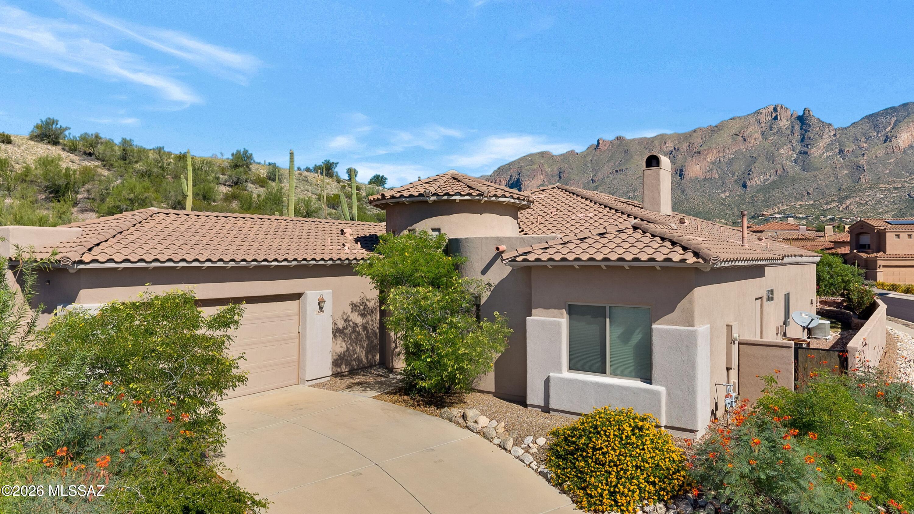 Beautiful A.F. Sterling single-story home in the gated community of Paloma Primera offering 4 bedrooms plus a flexible den/possible 5th bedroom. Celestial windows and skylights fill the home with natural light and enhance its clean, contemporary feel. With no interior steps, the thoughtful floor plan offers comfortable, easy living. Beautiful Catalina Mountain views can be enjoyed from the living room, while the backyard is a true showpiece with generous patio space, a built-in grill, and sweeping mountain and desert views. The yard opens to the adjoining common area, creating an expansive setting with beautiful Sonoran Desert scenery and a private oasis feel. A rare blend of privacy, views, natural light and easy single-level living in a beautiful gated setting. Make it yours today!